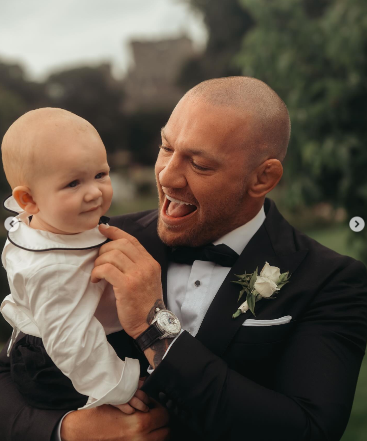 Conor McGregor smiles at his son, Mack, during Terry Kavanagh and Erin McGregor's wedding on August 17, 2024 | Source: Instagram/thenotoriousmma