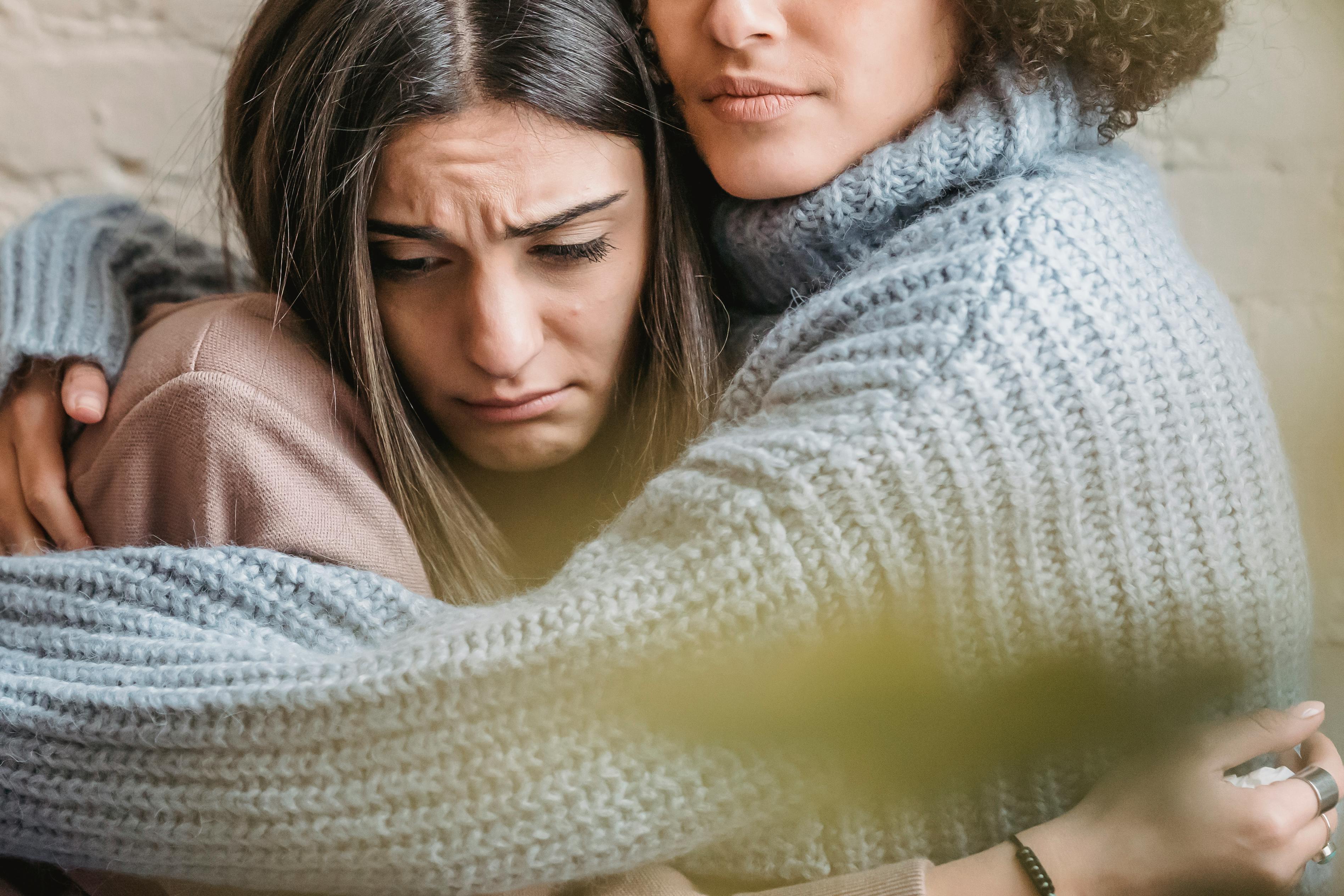 An upset woman being comforted by a friend | Source: Pexels