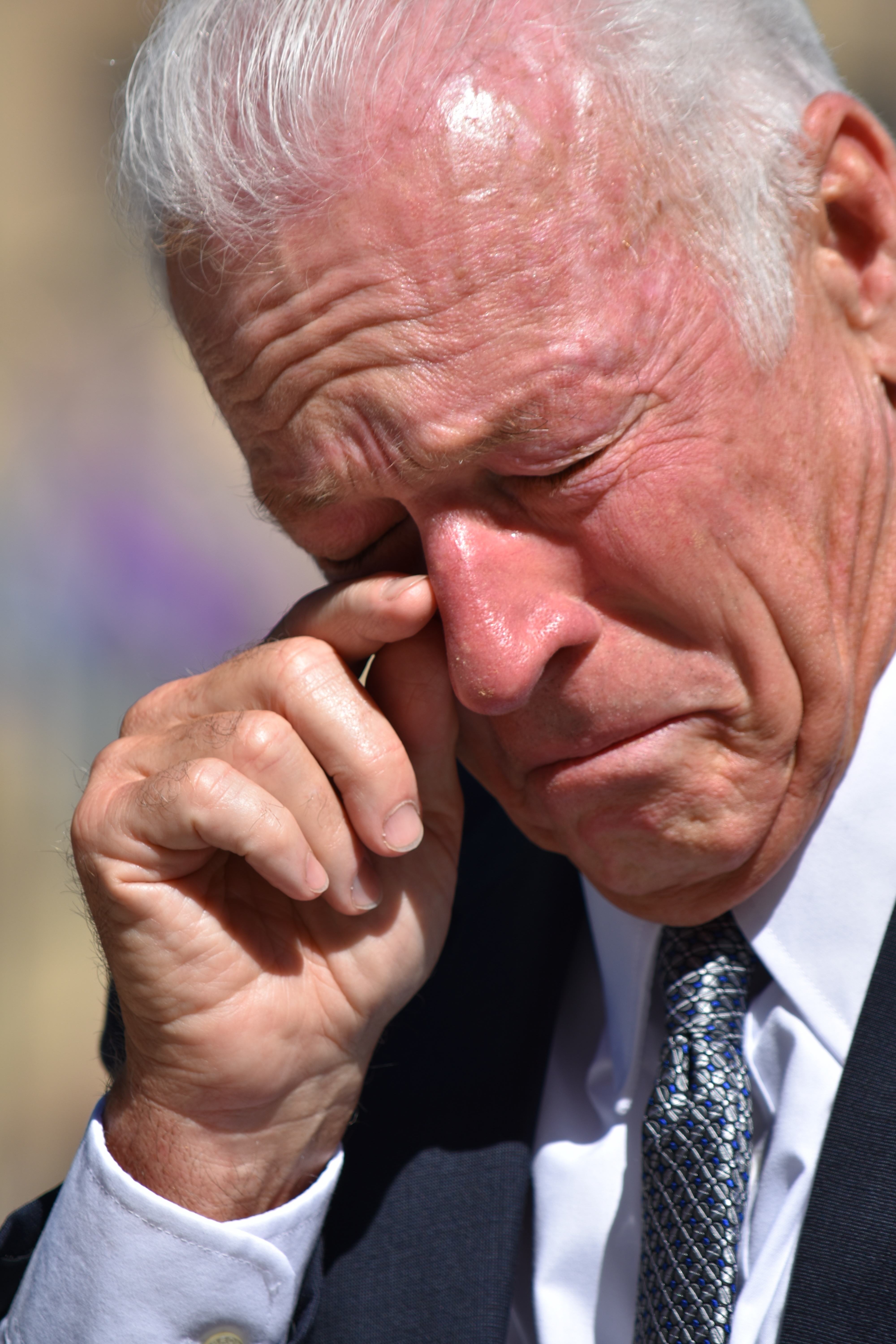 A senior man wiping his tears | Source: Shutterstock