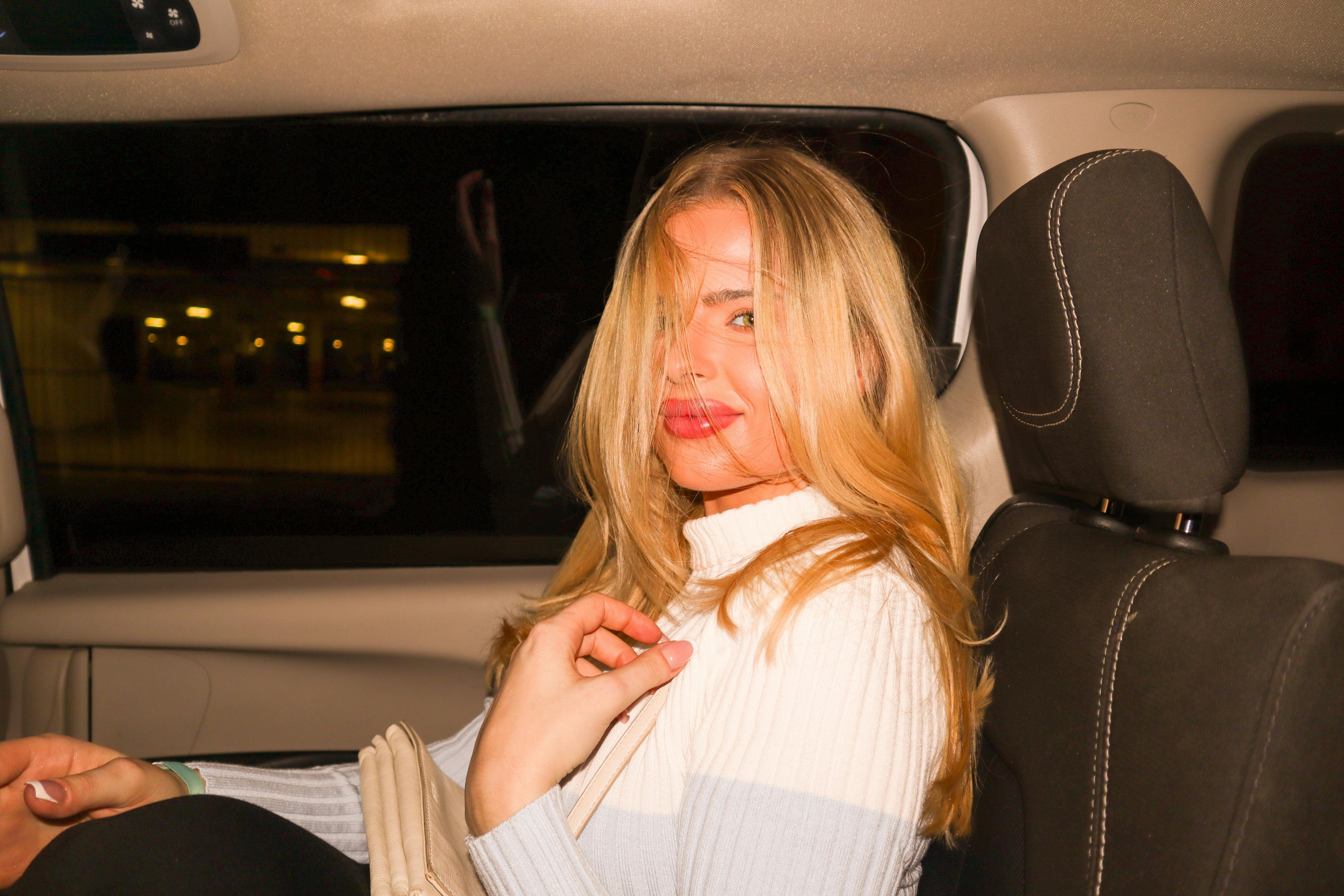 A happy woman in a car | Source: Pexels