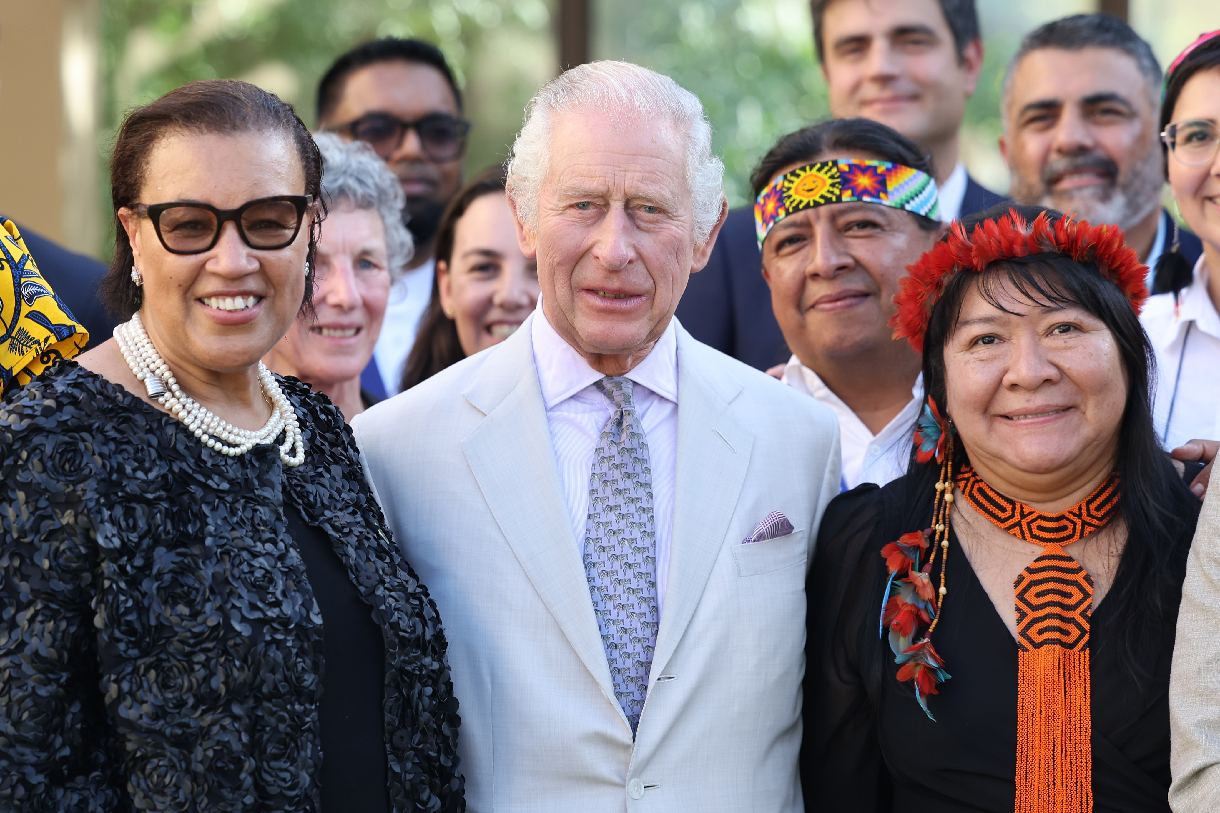 King Charles III poses with The Baroness Scotland of Asthal Patricia Scotland (L), Joênia Wapixana (R), and other representatives at the Commonwealth and Nature reception during COP28 in Dubai, United Arab Emirates on November 30, 2023. | Source: Getty Images