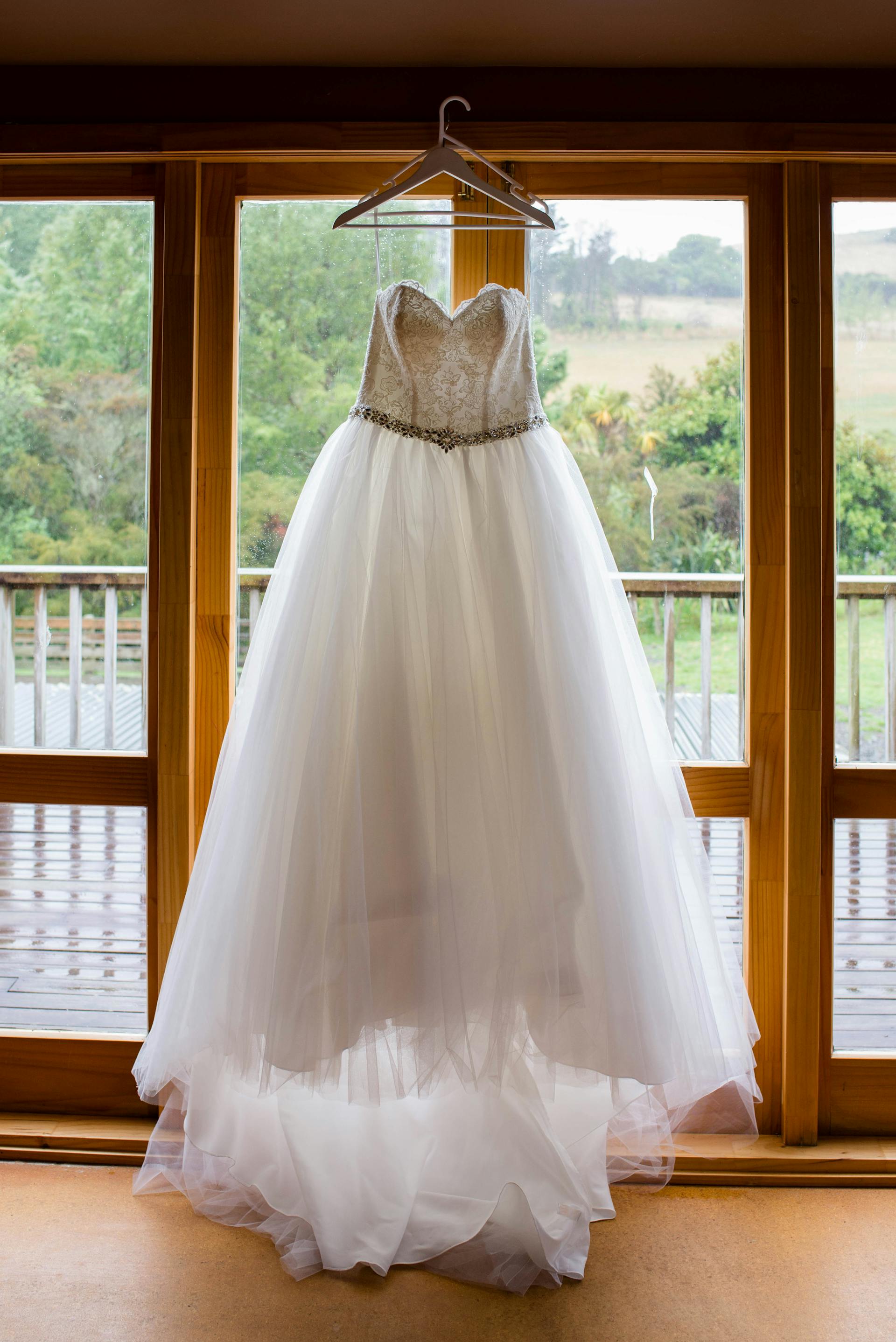 A wedding dress hanging from the window | Source: Pexels