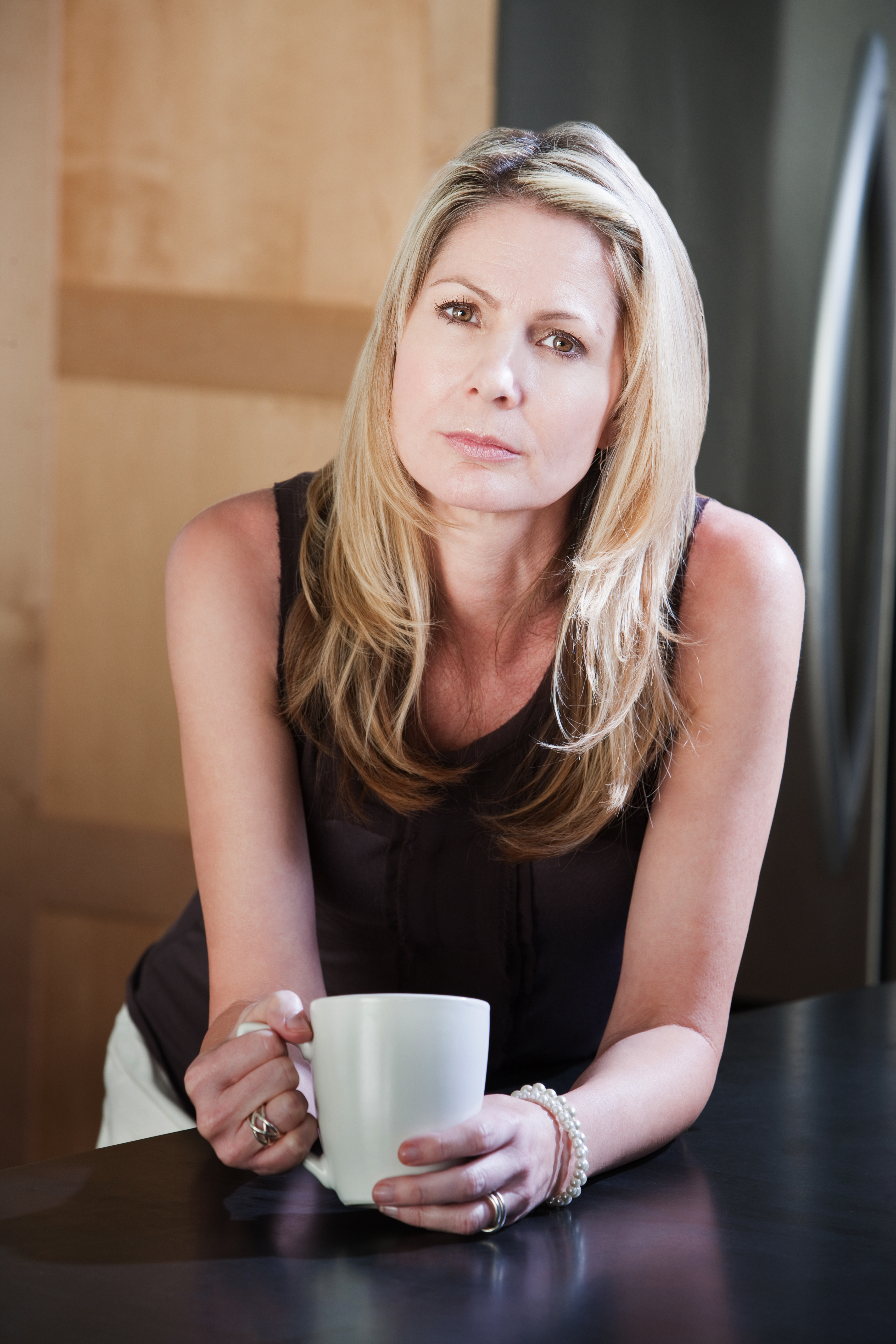 A middle-aged woman holding a coffee mug | Source: Shutterstock