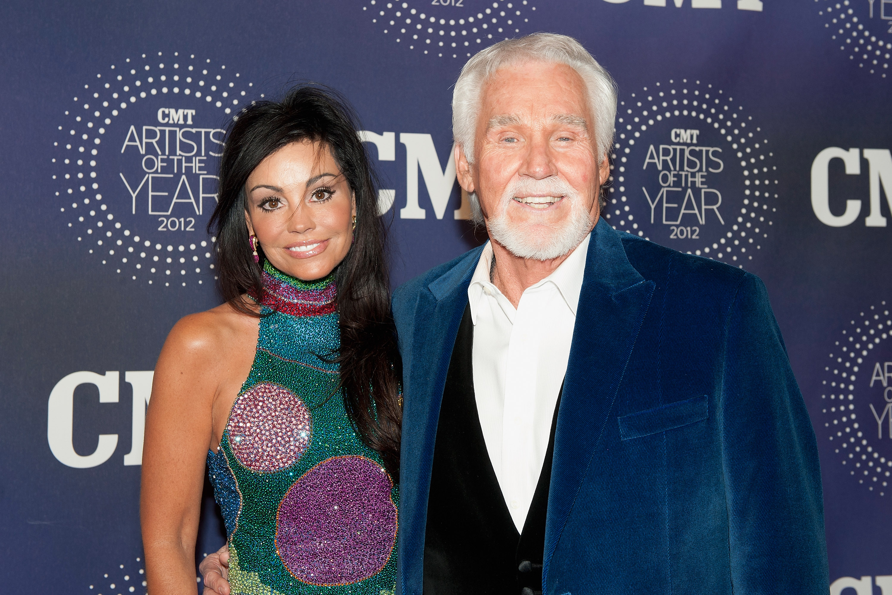Wanda and Kenny Rogers pose together on the red carpet at the 2012 CMT 'Artists of the Year' Awards at The Factory At Franklin on December 3, 2012, in Franklin, Tennessee | Source: Getty Images