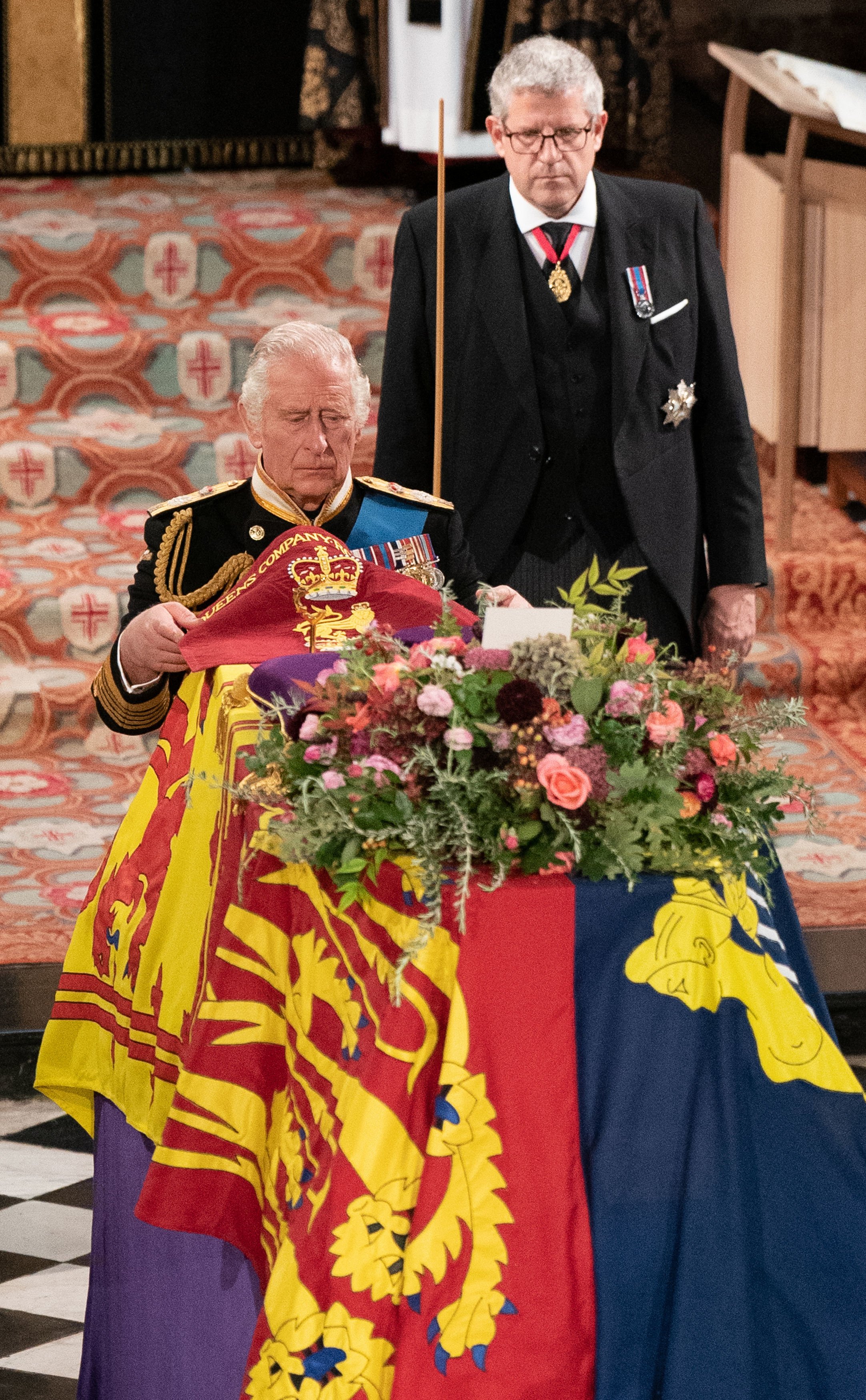 King Charles III places the Queen's Company Camp Colour of the Grenadier Guards on the coffin during the Committal Service at St George's Chapel in Windsor Castle on September 19, 2022 in Windsor, England | Source: Getty Images 