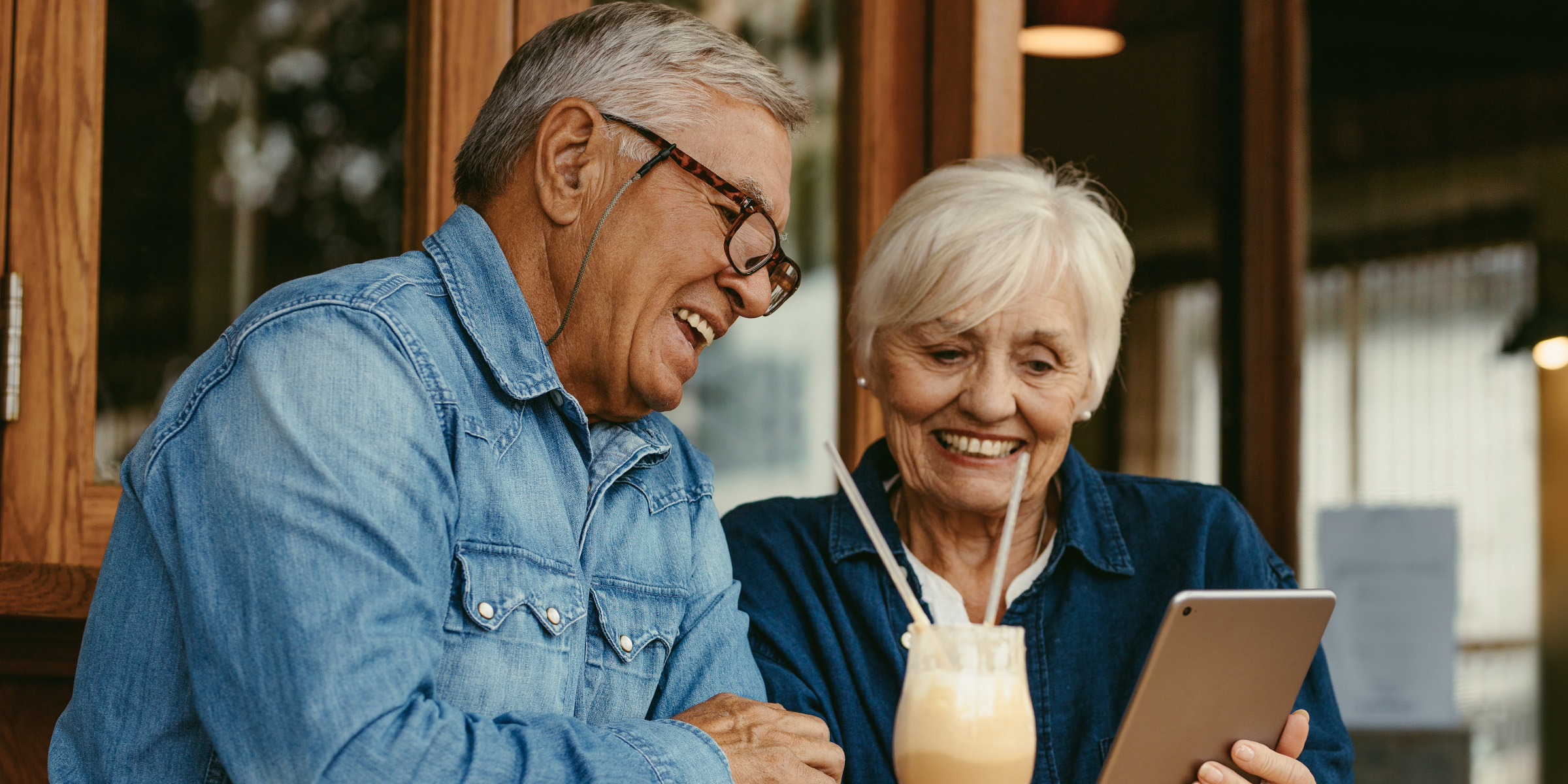 A happy elderly couple looking at a tablet | Source: Shutterstock