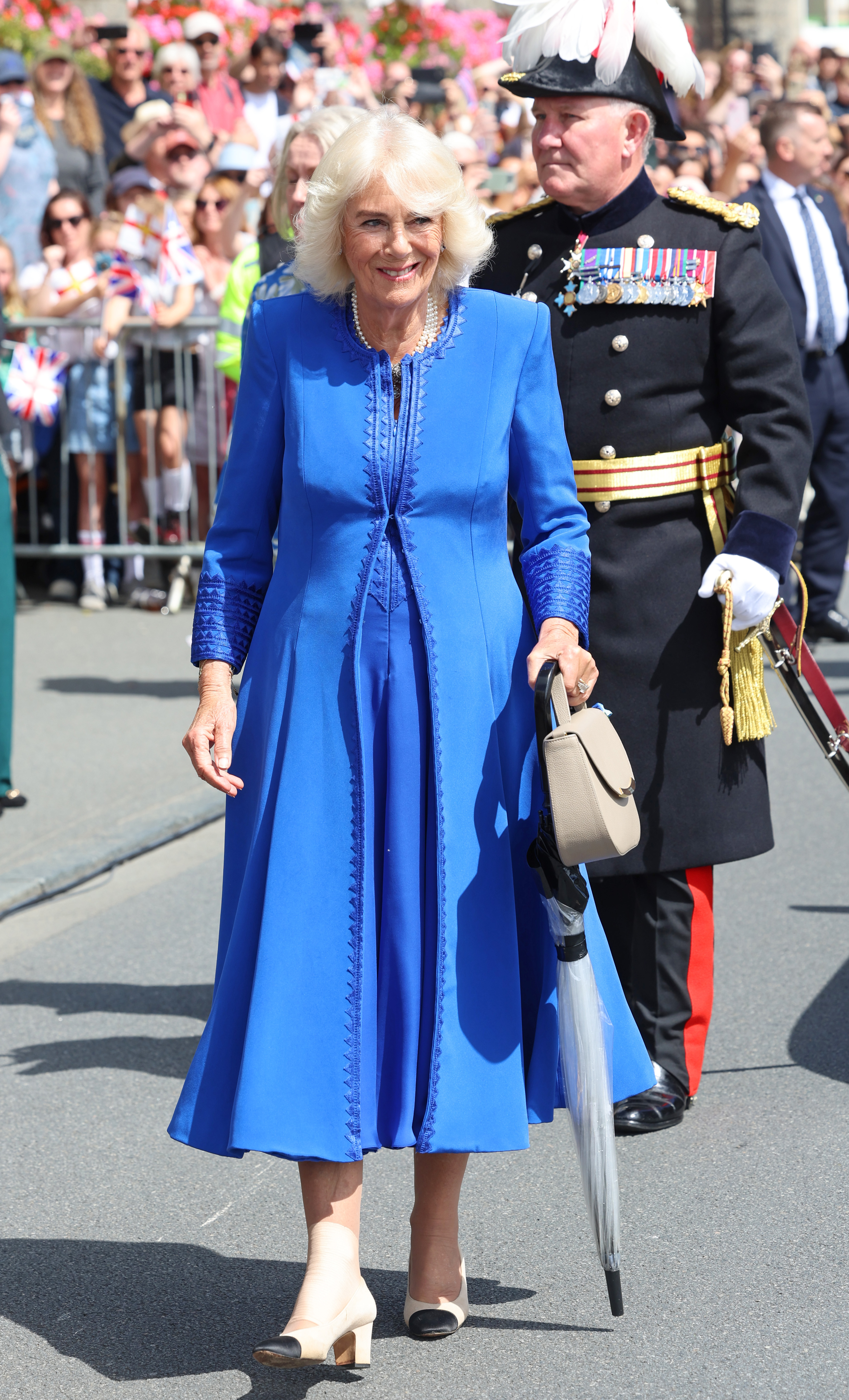 Queen Camilla arrives to enthusiastic cheers from well-wishers before the Special Sitting of Guernsey’s Parliament during her official visit to St. Peter Port, Guernsey on July 16, 2024. | Source: Getty Images