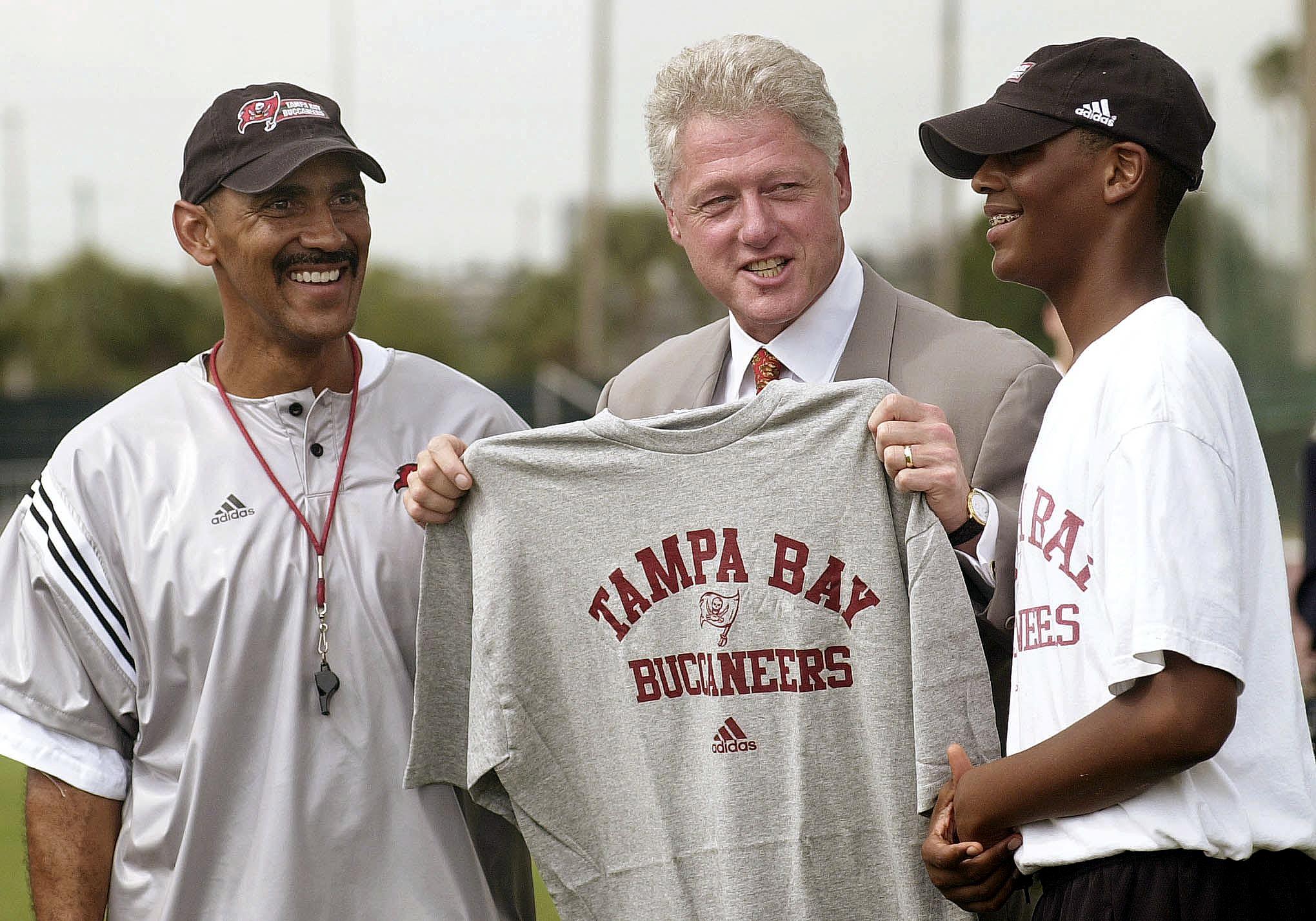 US President Bill Clinton with coach Tony Dungy and his son James, at the University of Tampa in 2000, in Tampa , Florida. | Source: Getty Images