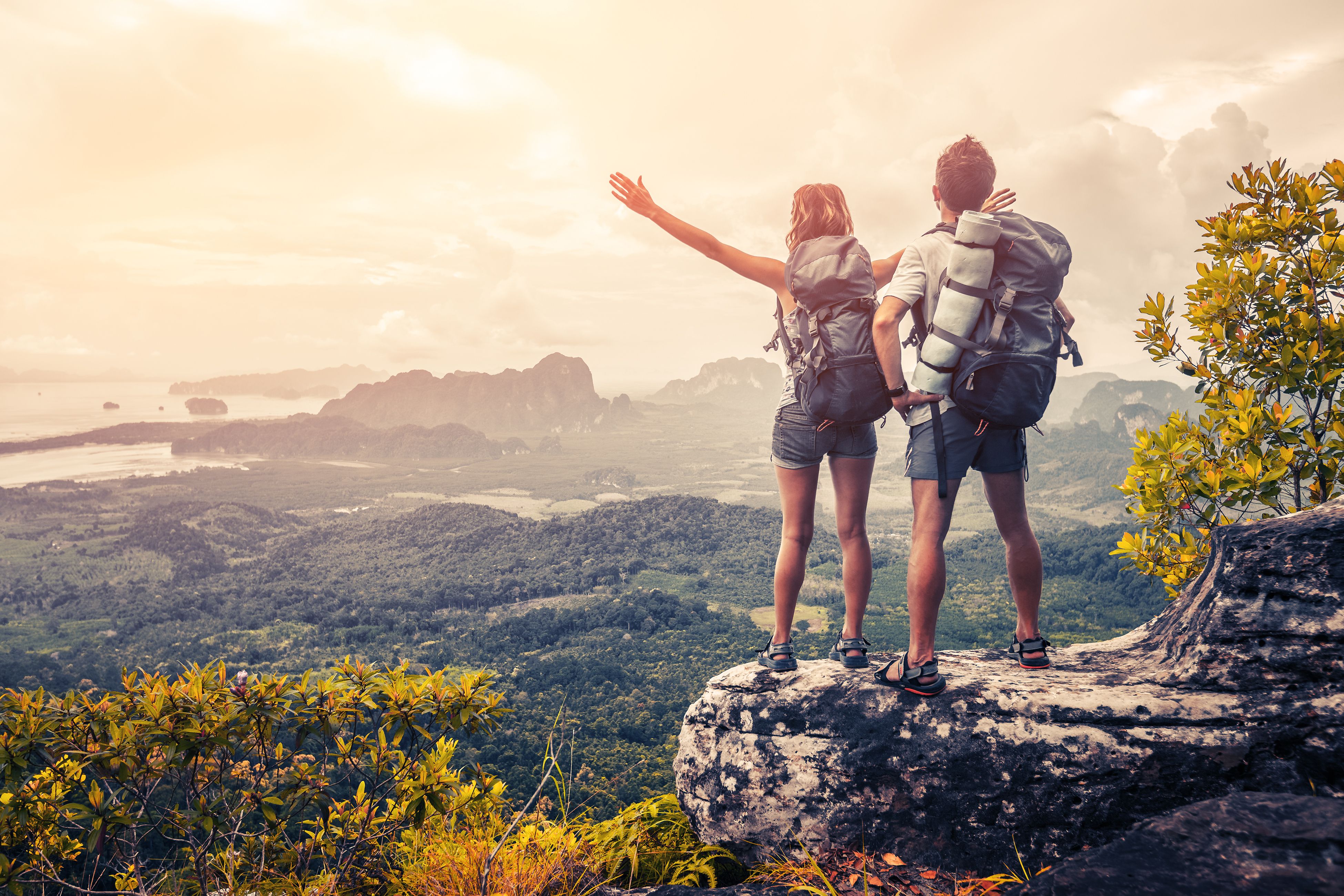 A couple on an adventure hiking up the mountains. | Source: Shutterstock