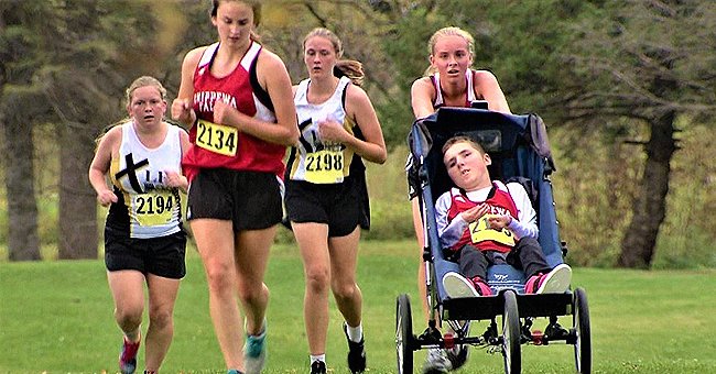 A picture of Susan Bergeman completing a 3.1-mile high school cross country race, while pushing her brother | Photo: youtube.com/KARE 11 