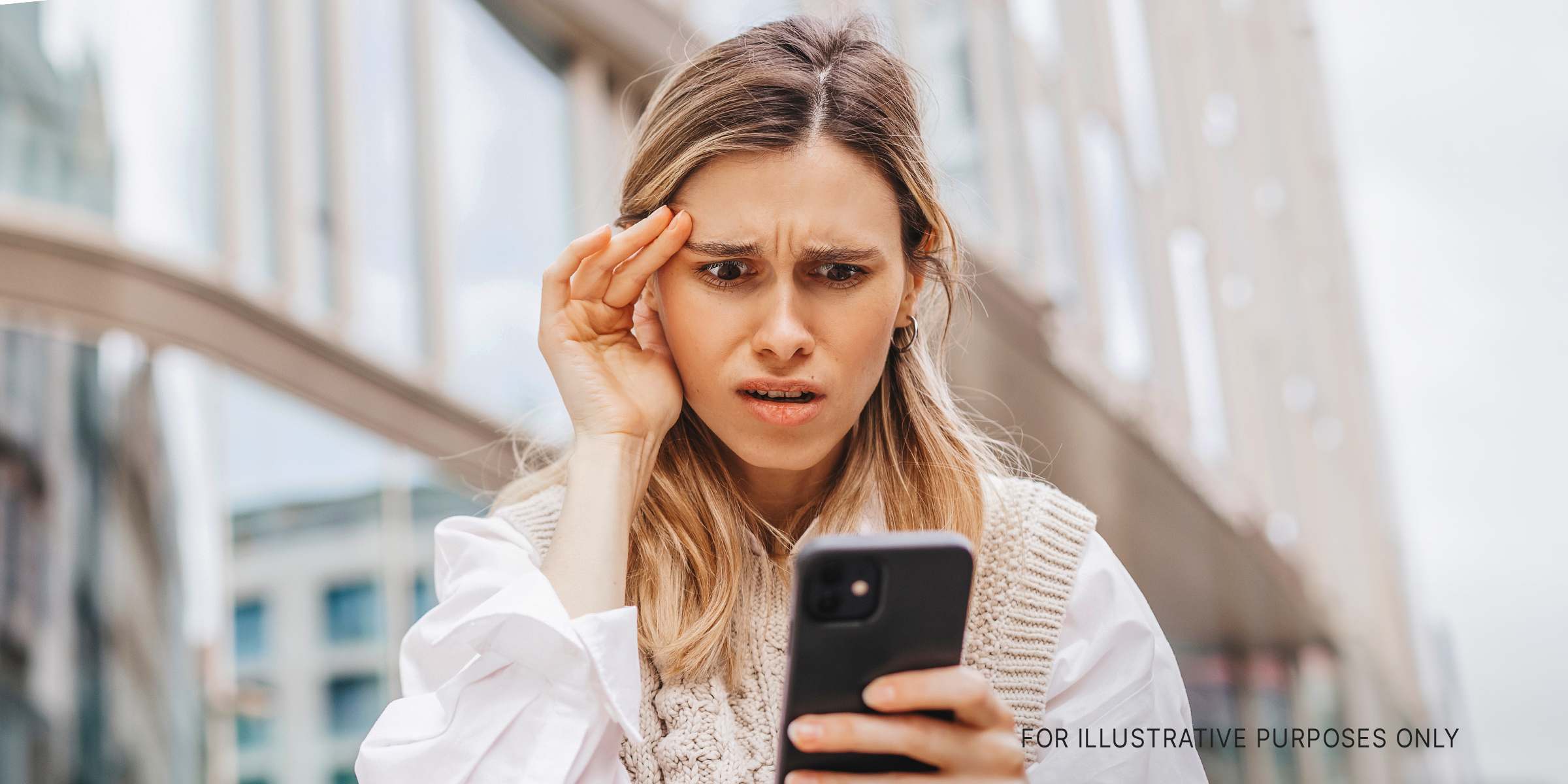 A woman looking at her phone | Source: Shutterstock