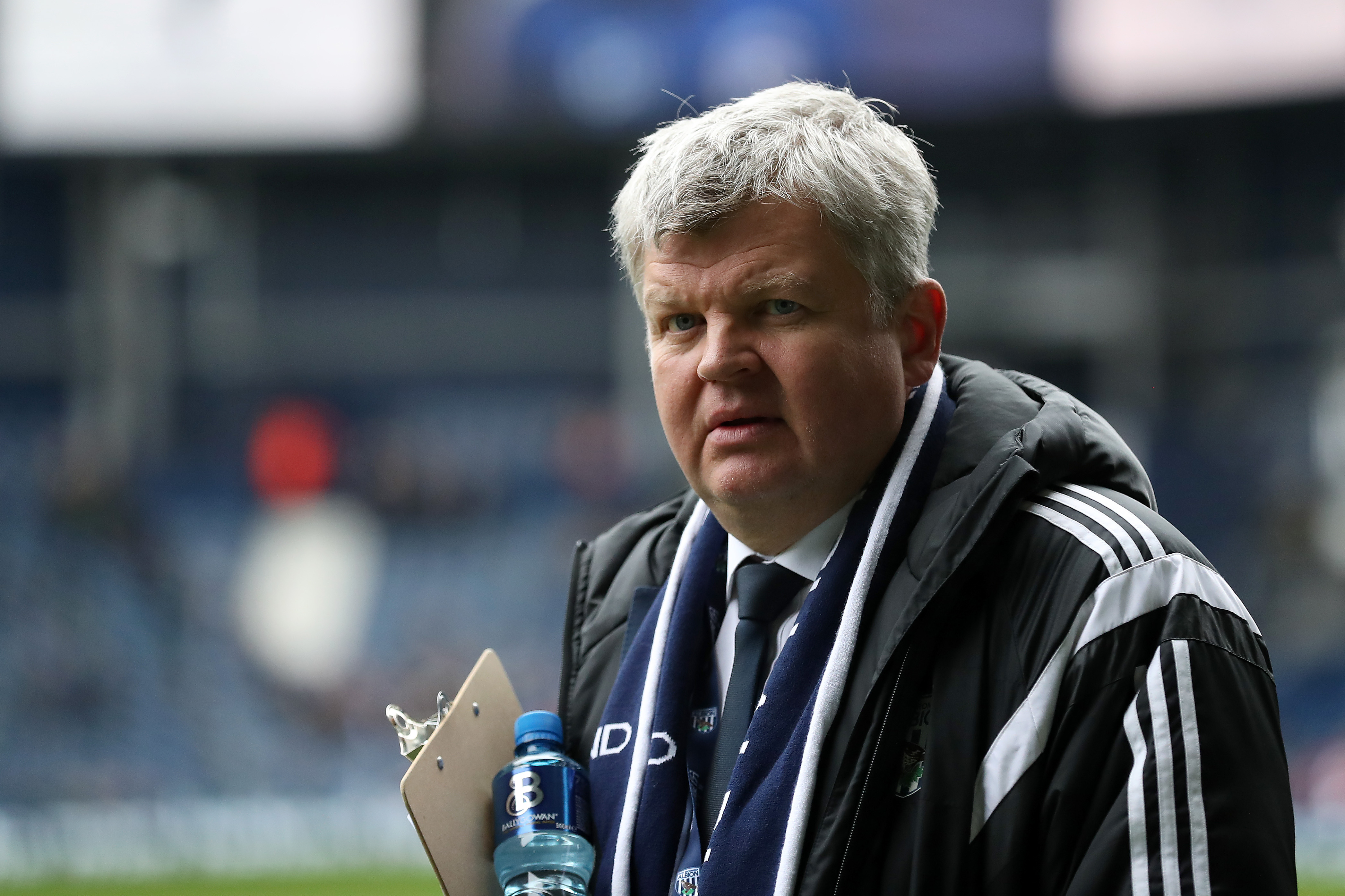 Adrian Chiles arrives pitch side for the start of the Cyrille Regis Tributes during the Premier League match between West Bromwich Albion and Southampton at The Hawthorns on 3 February 2018 in West Bromwich, England. | Source: Getty Images