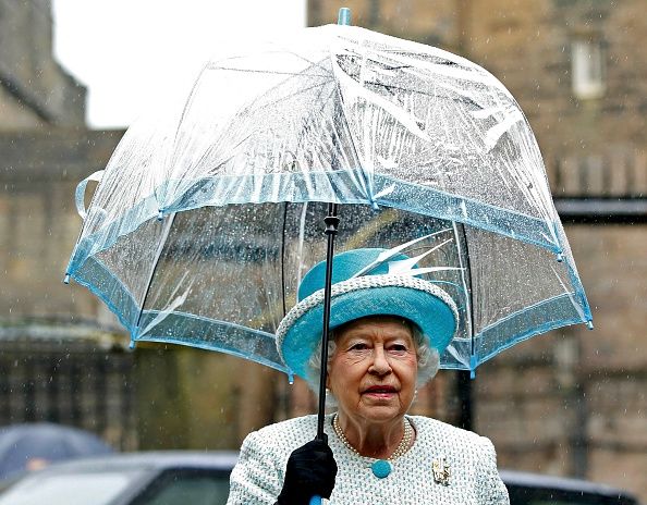 Queen Elizabeth II holds an umbrella as she visits Lancaster Castle on May 29, 2015, in Lancaster, England | Photo: Andrew Yates - Pool/Getty Images