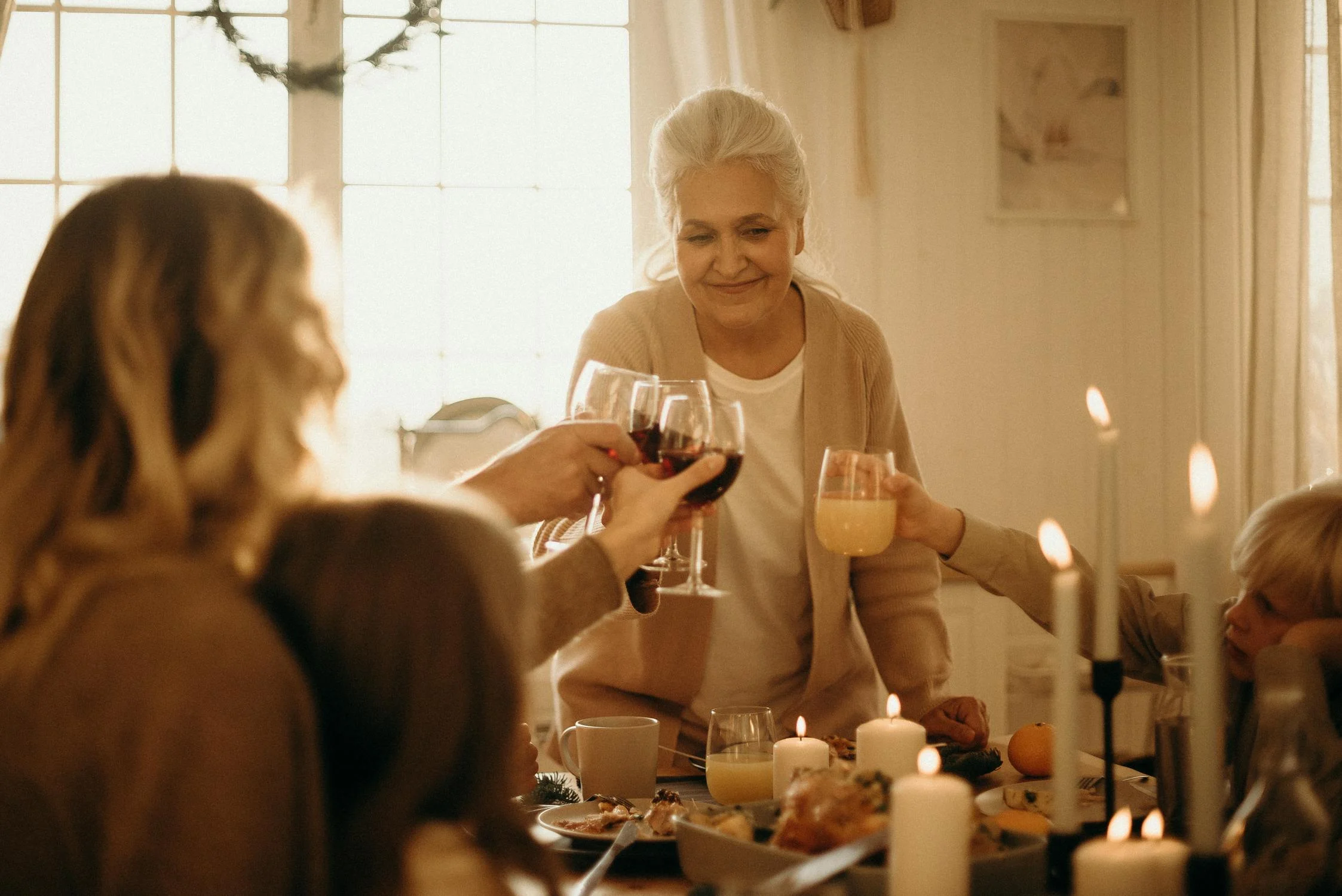 A woman toasting at a dinner | Source: Pexels