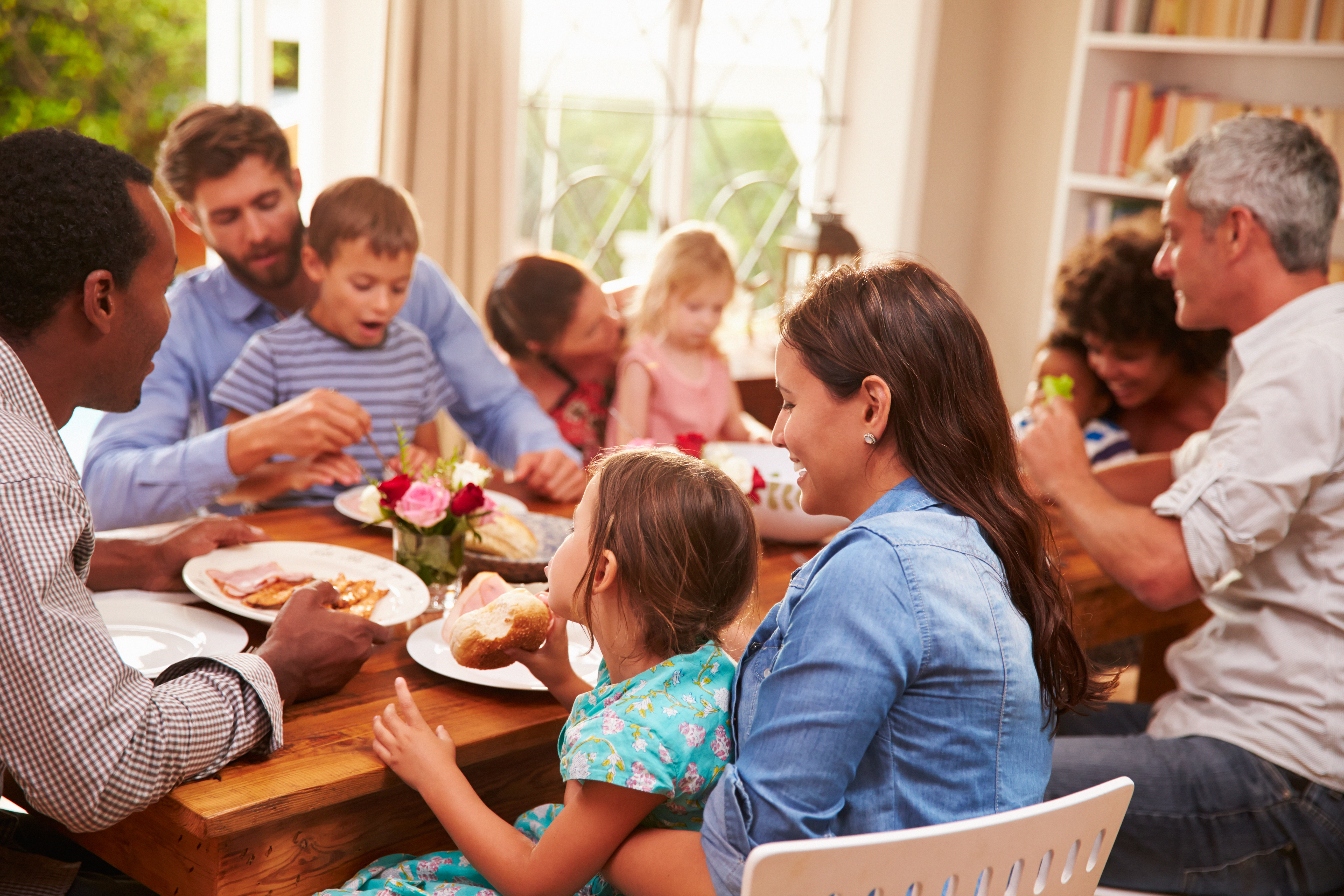 A family sitting at dinning table | Source: Shutterstock