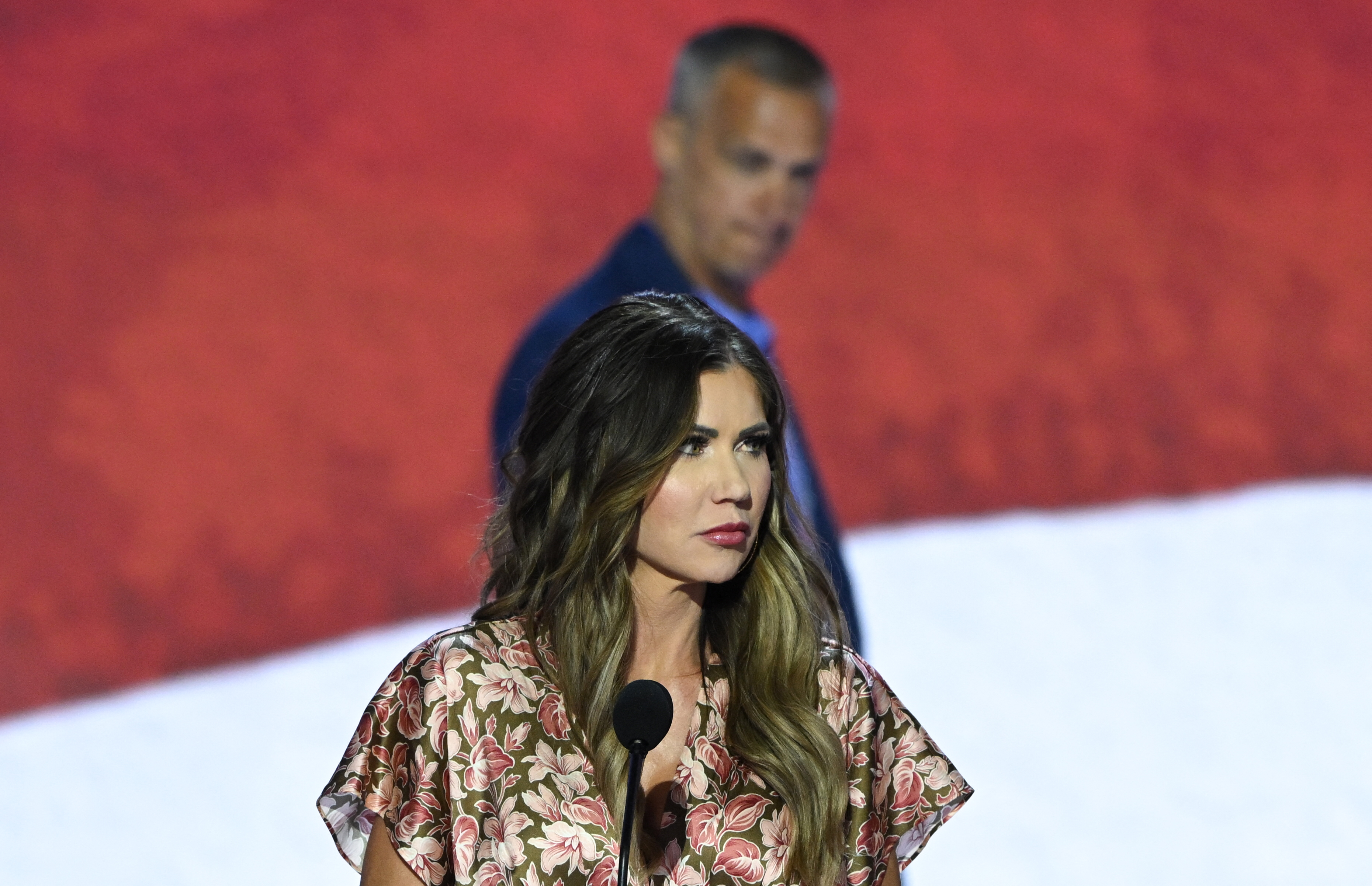 Kristi Noem looks on as Corey Lewandowski appears behind her at the Fiserv Forum ahead of the Republican National Convention in Milwaukee, Wisconsin on July 14, 2024. | Source: Getty Images