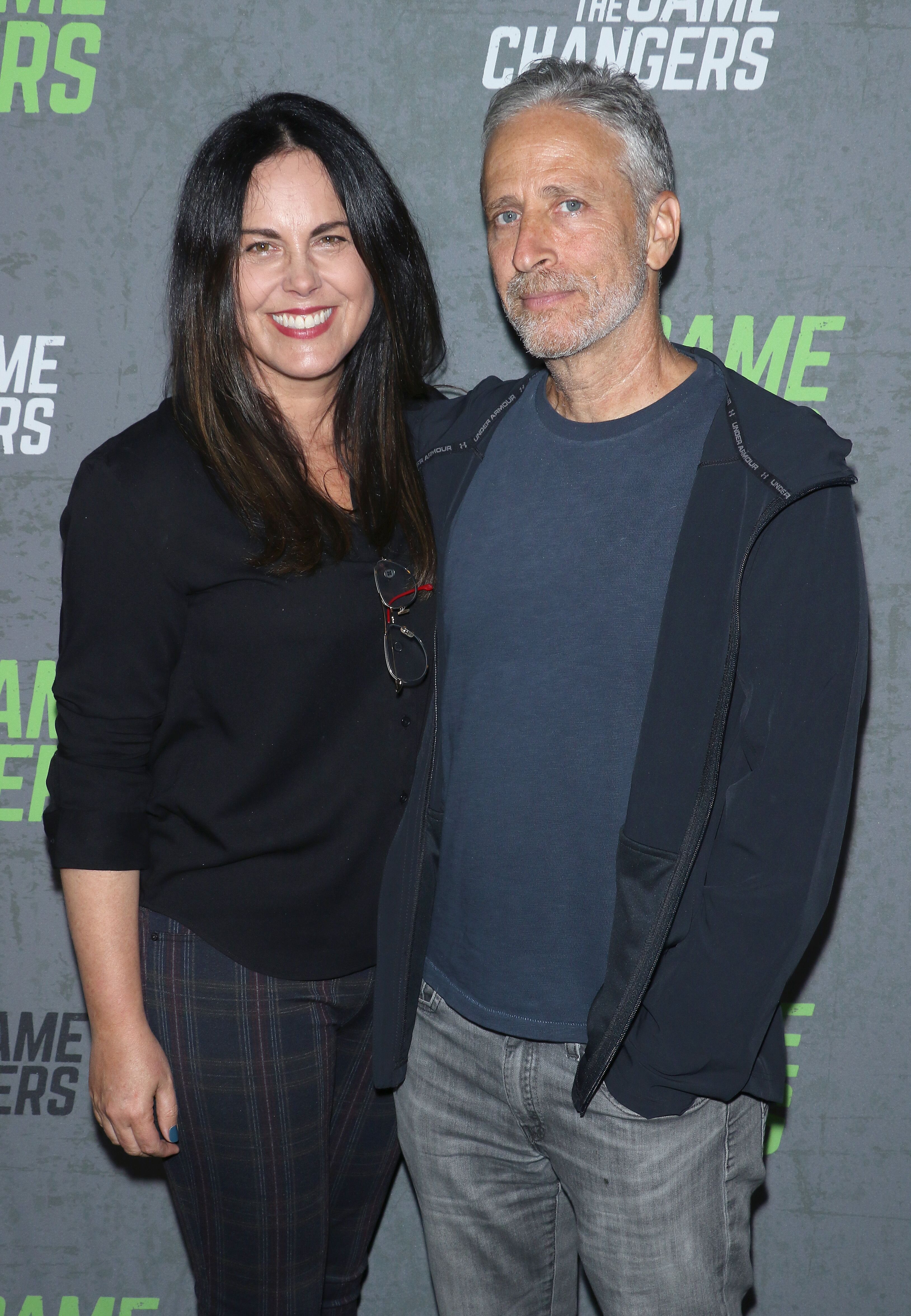 Tracey McShane and comedian Jon Stewart attend the "The Game Changers" New York premiere. | Source: Getty Images
