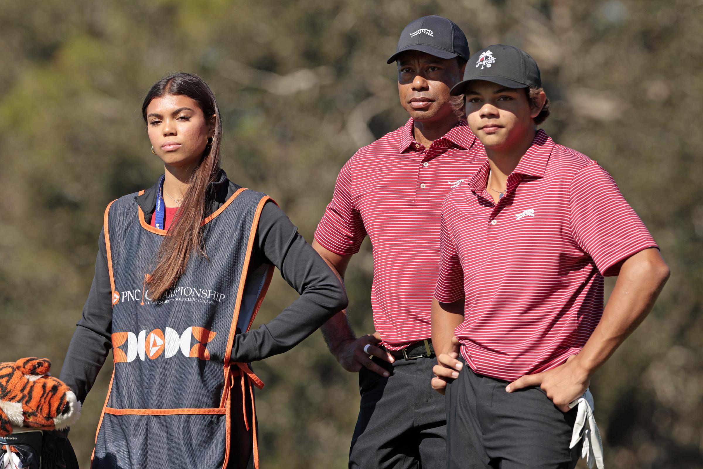 Tiger Woods stands with daughter Sam Woods and son Charlie Woods on the second tee at the PNC Championship on December 22, 2024 — a rare full family moment on the course.