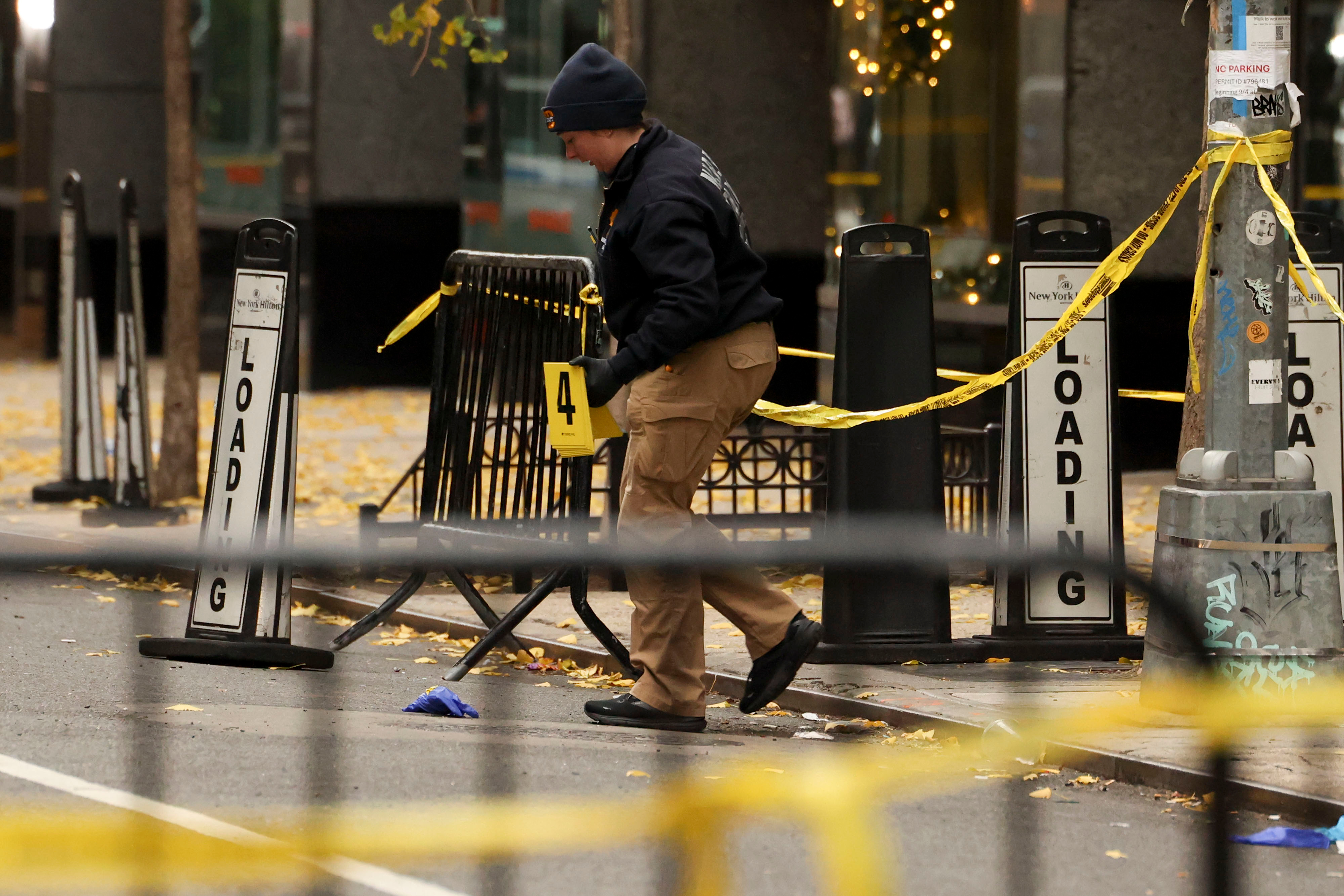 A law enforcement officer at the crime scene marker outside the New York Hilton Midtown on December 4, 2024, in Manhattan, New York. | Source: Getty Images