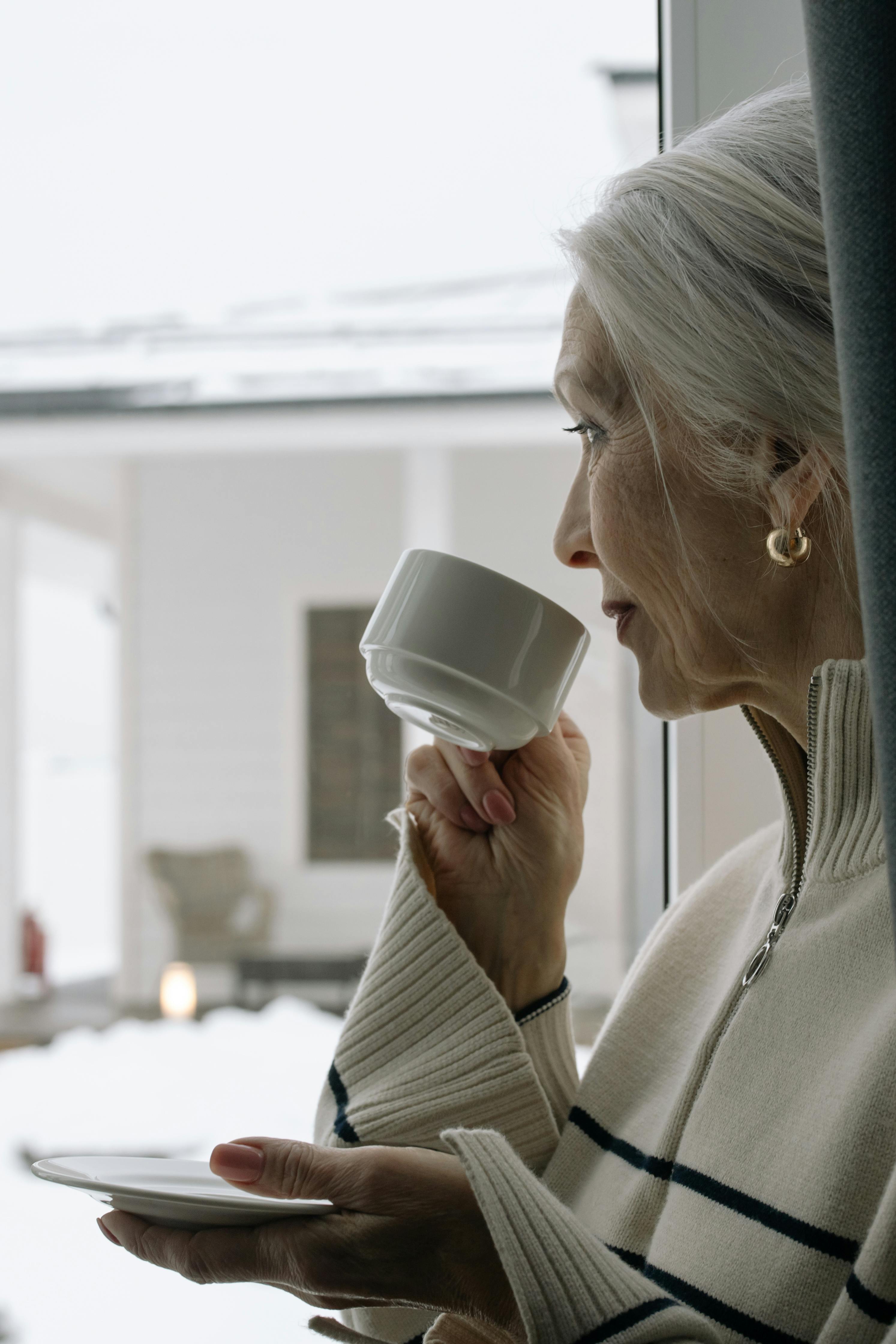 An older woman drinking from a cup | Source: Getty Images