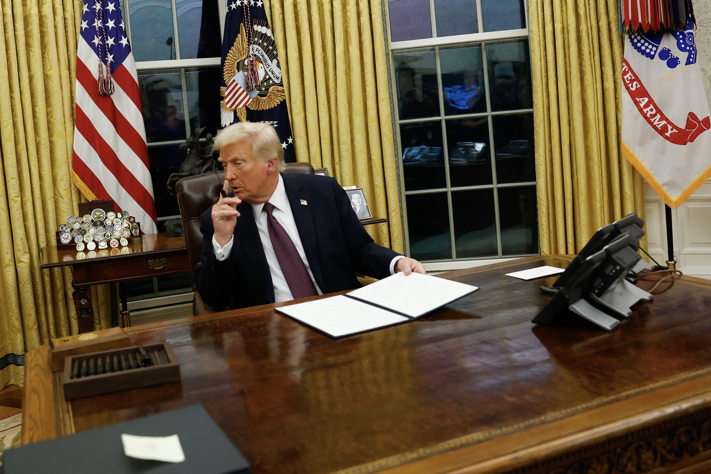 President Donald Trump signs executive orders in the Oval Office of the White House on January 20, 2025, in Washington, DC. | Source: Getty Images