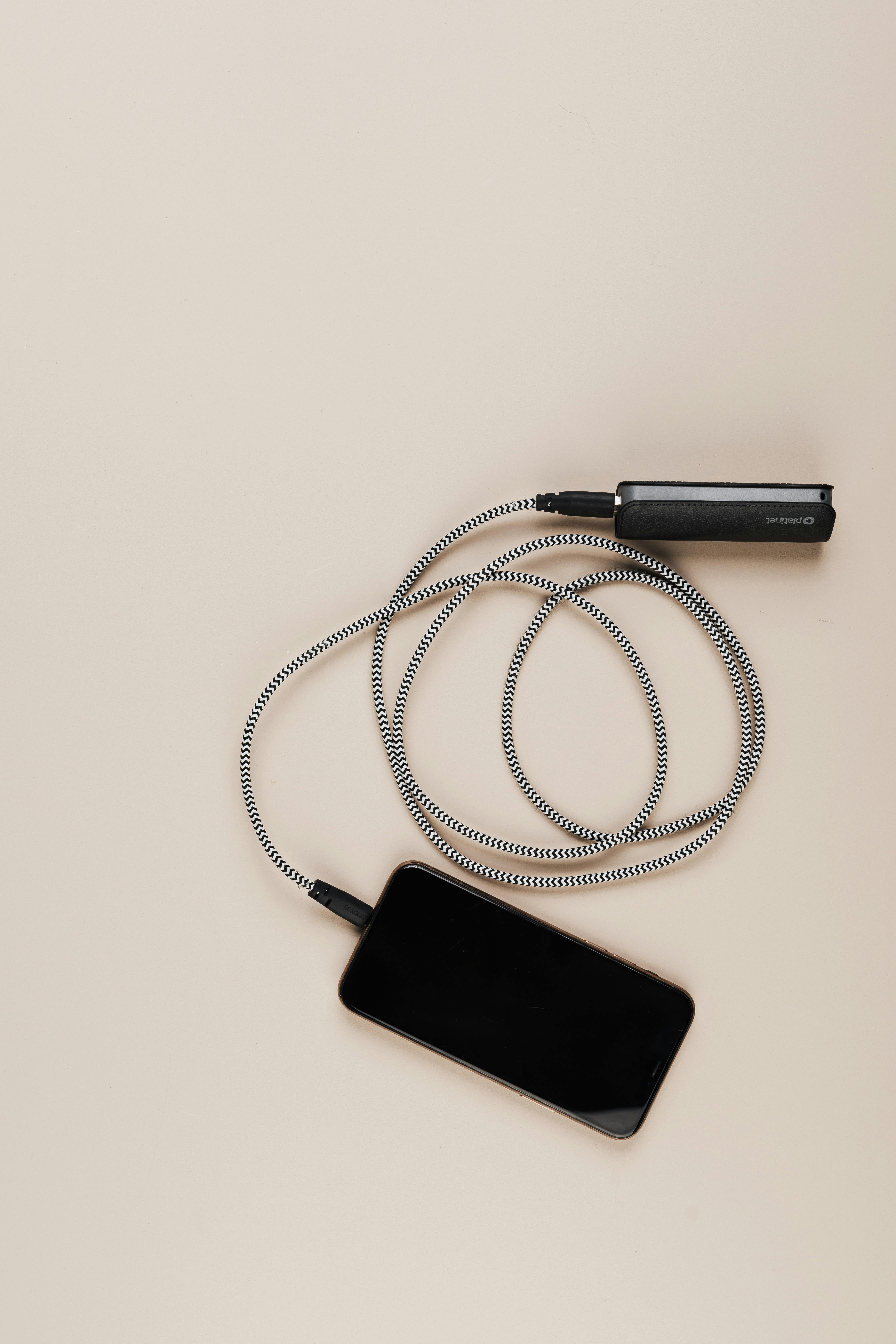 A phone charging through a power bank | Source: Pexels