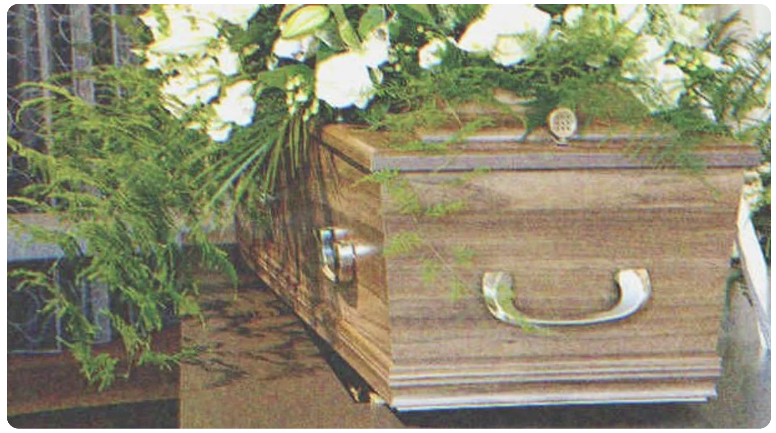 A coffin with flowers on it | Source: Shutterstock
