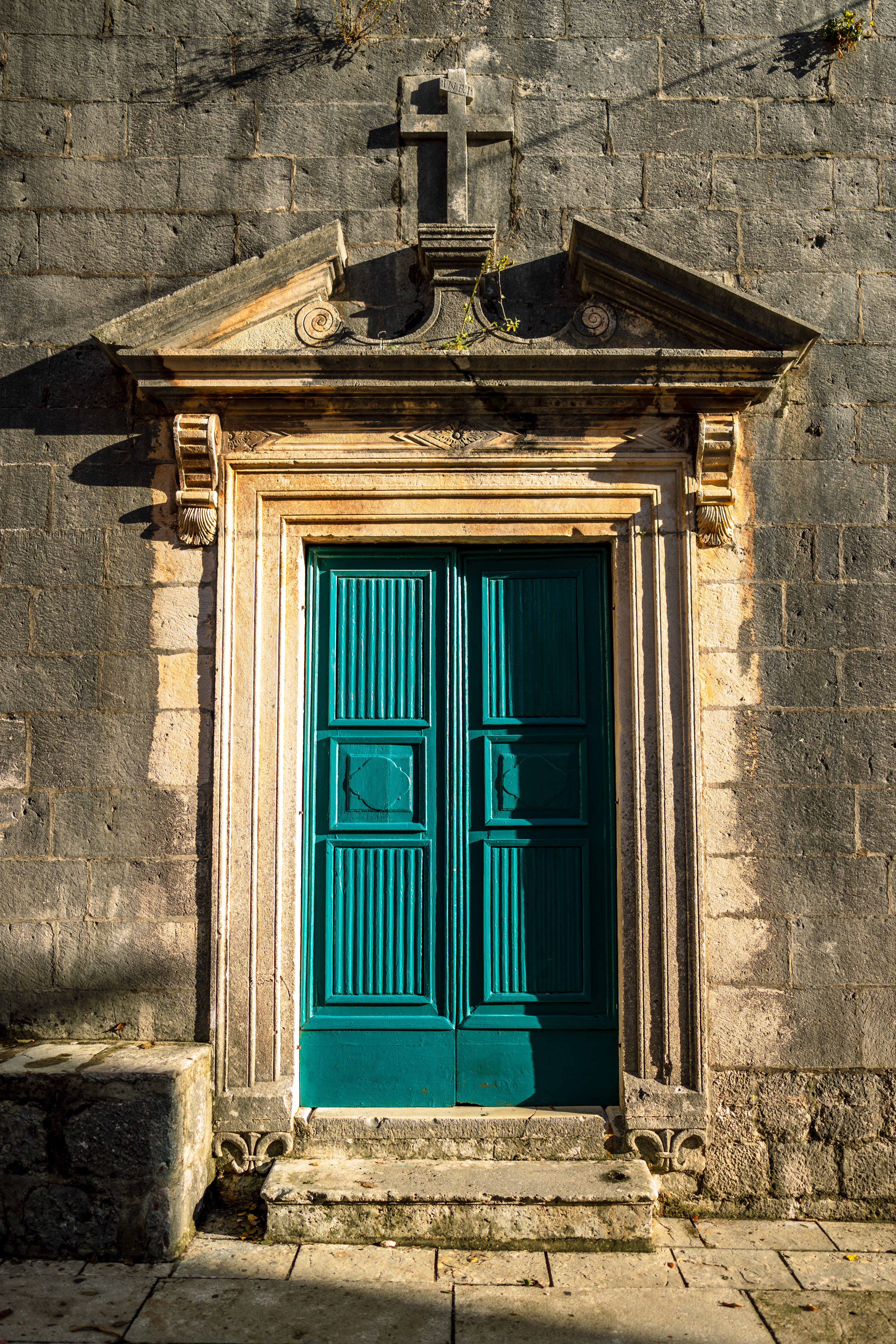 A wooden blue door of a stone building. | Source: Pexels