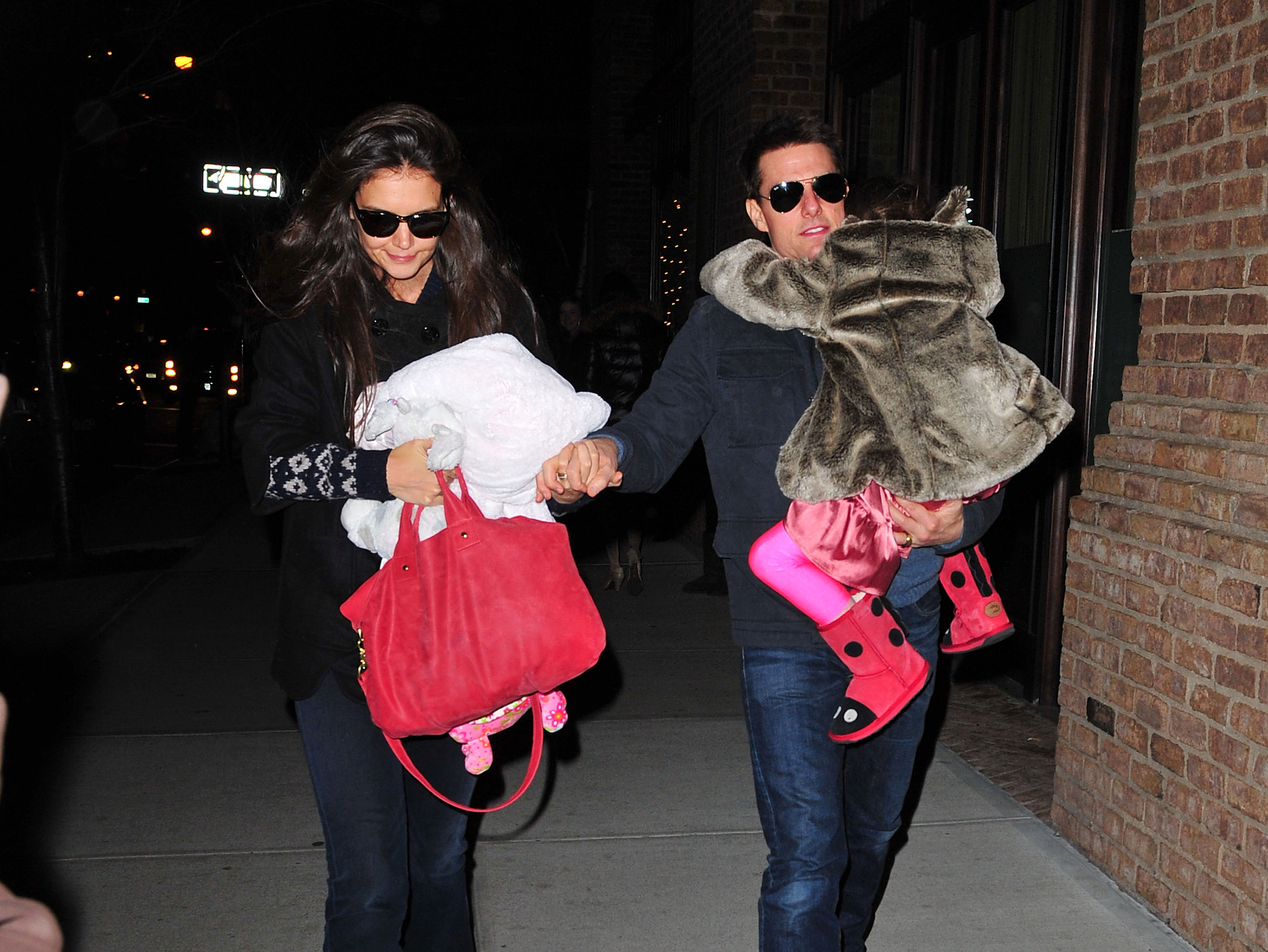 Katie Holmes, Tom Cruise, and Suri Cruise seen on the streets of Manhattan in New York City, on December 17, 2011. | Source: Getty Images