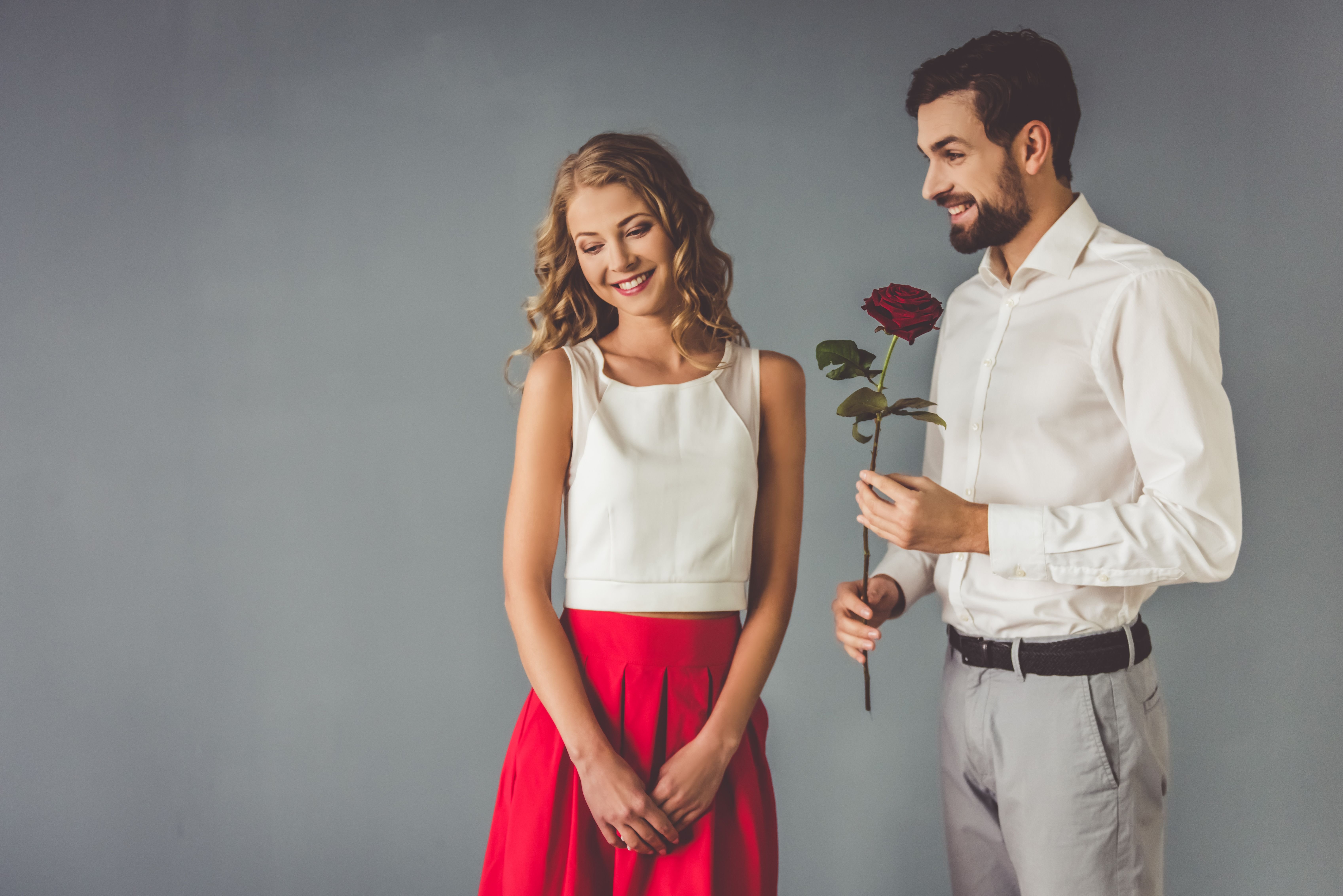 A man gives a woman flowers. | Source: Shutterstock