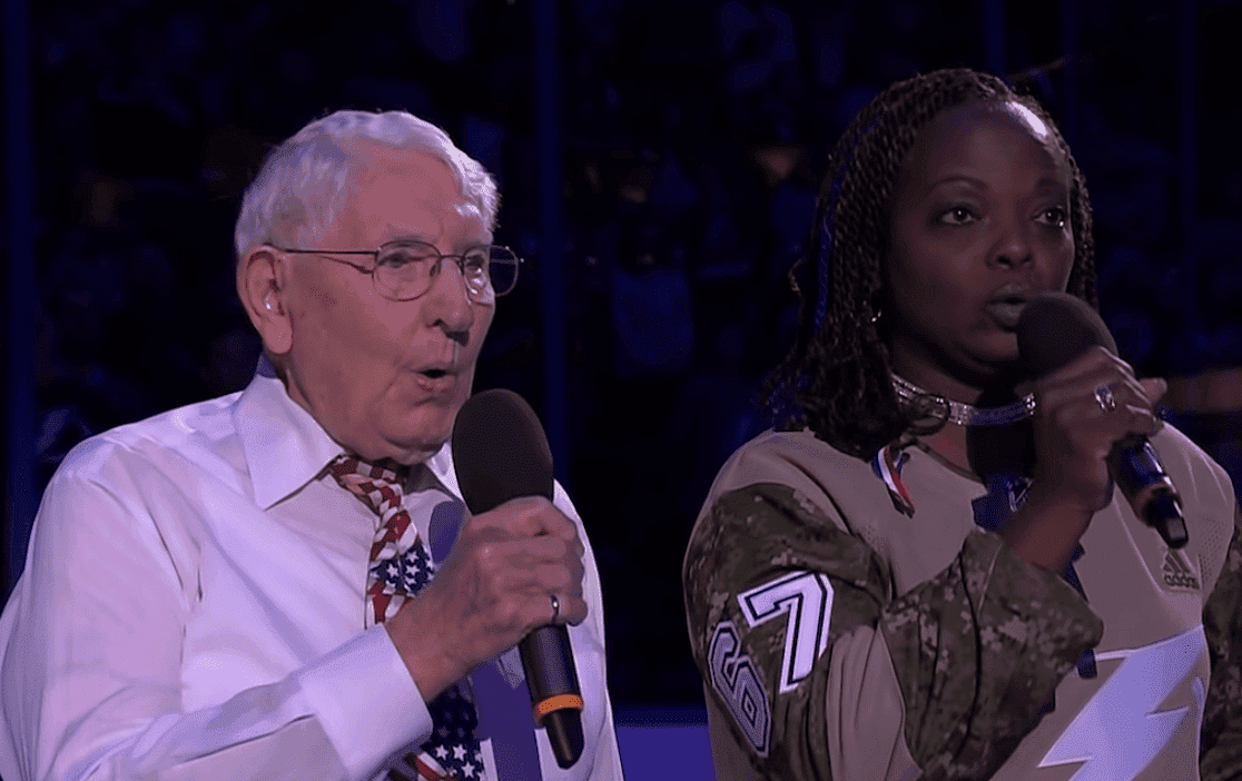 Retired veterans Sonya Bryson and Robert McClintock sing the national anthem as the Tampa Bay Lightning celebrate Military Appreciation Night at Amalie Arena. | Source: YouTube/NHL  