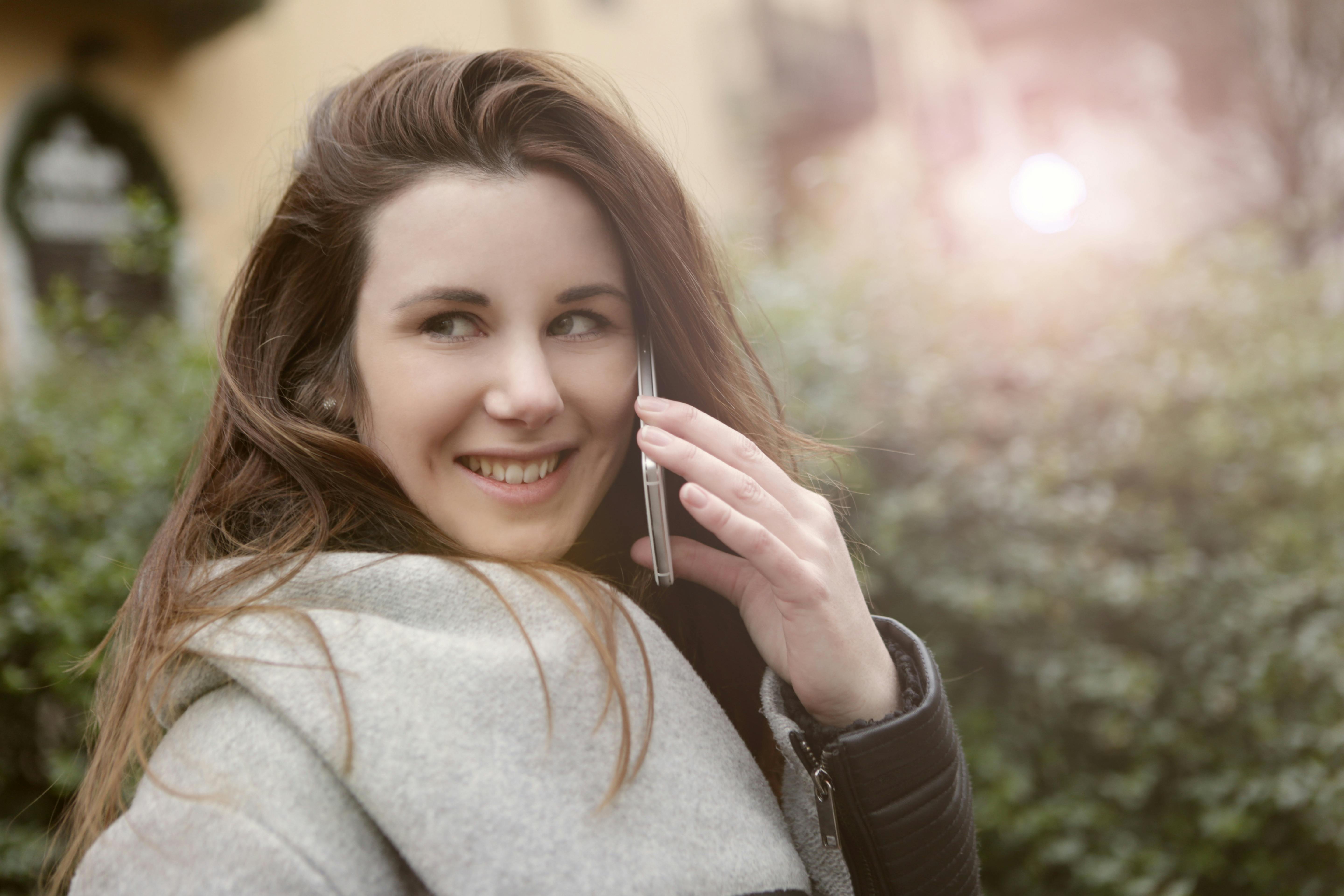 A happy woman speaking on the phone | Source: Pexels