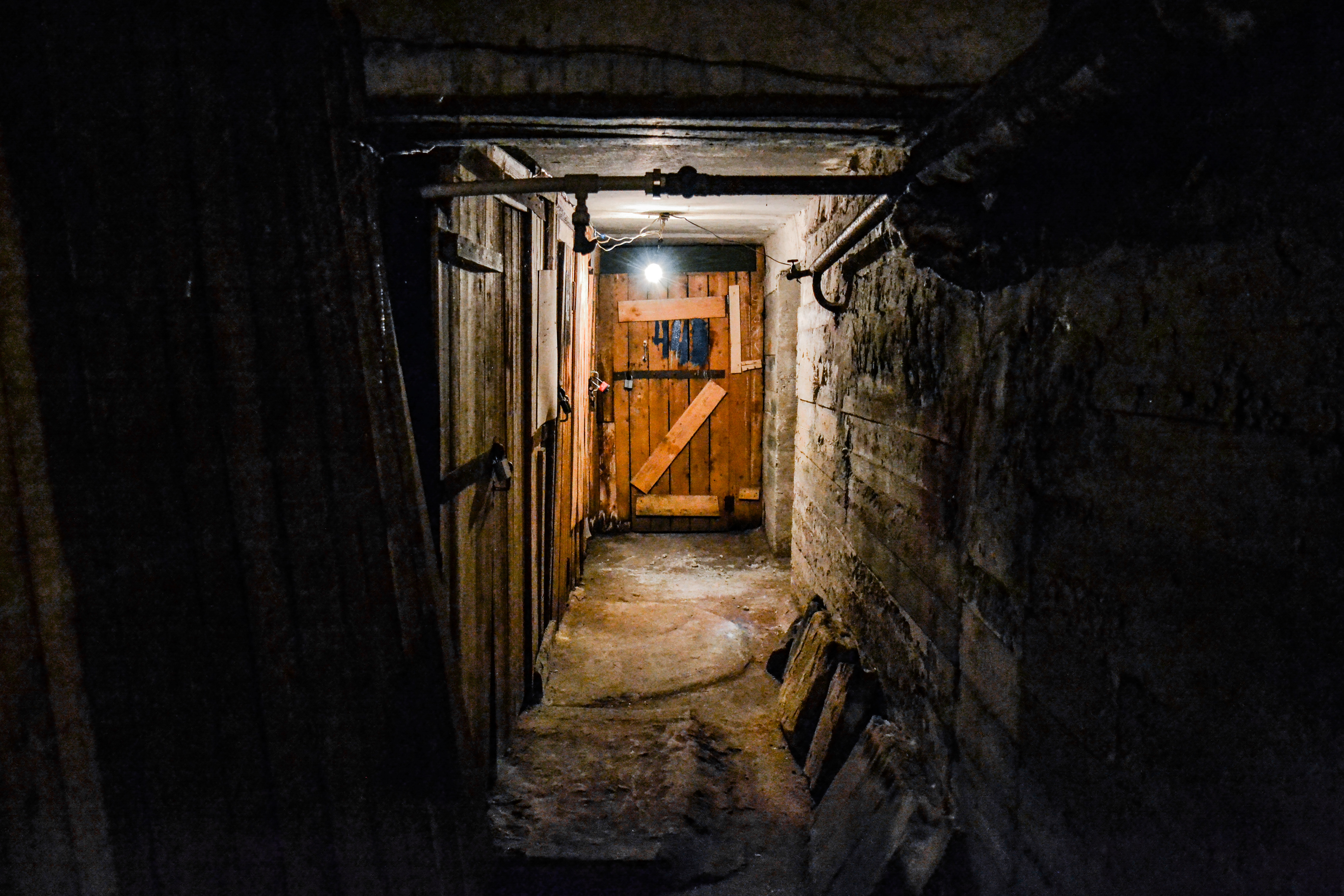 A scary dark concrete corridor in the basement | Source: Shutterstock.com
