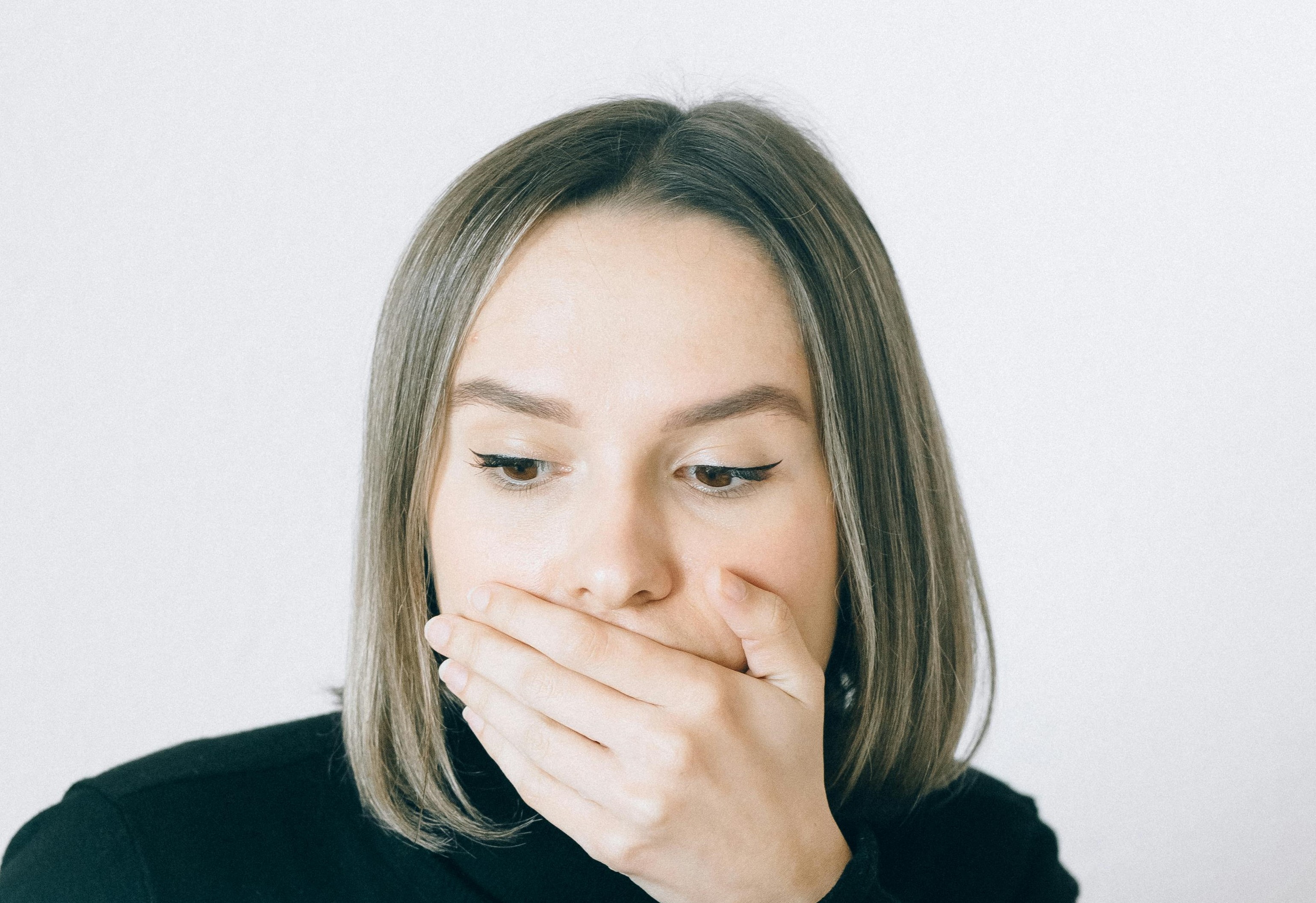 A shocked woman covering her mouth | Source: Pexels