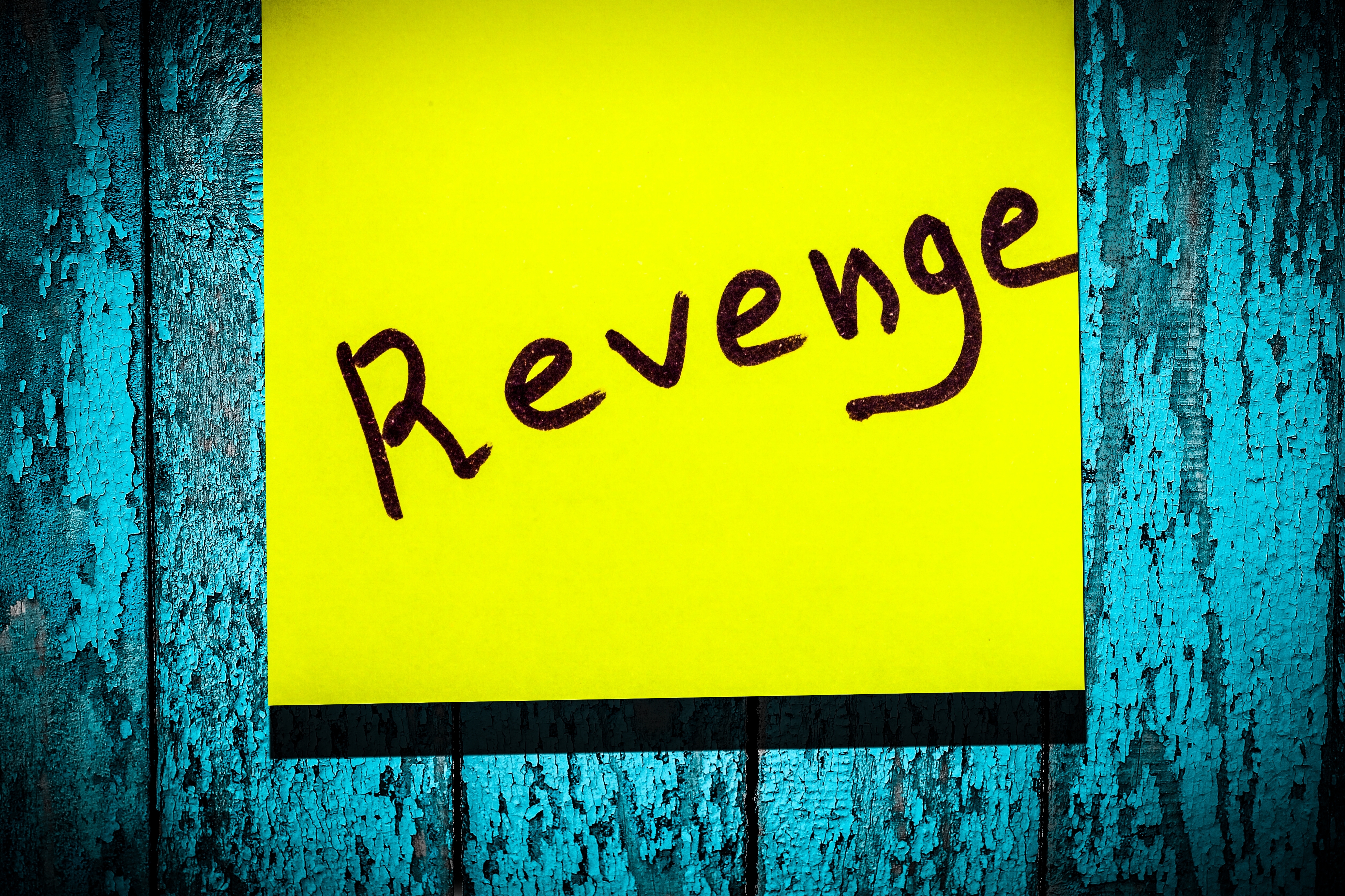 A yellow sticky note with the word "Revenge" | Source: Shutterstock