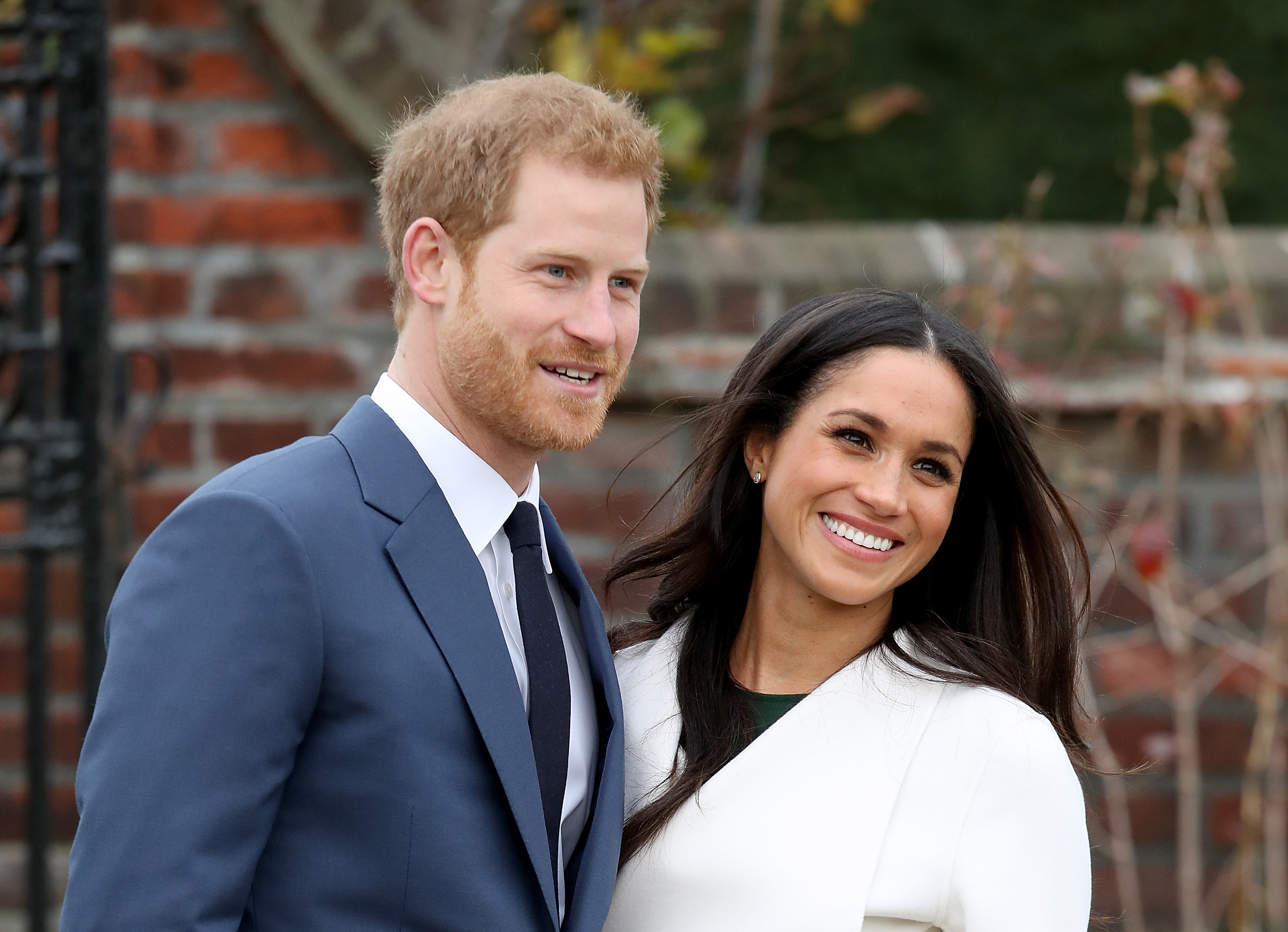 Prince Harry and Meghan Markle during an official photocall to announce their engagement at The Sunken Gardens at Kensington Palace on November 27, 2017, in London, England. | Source: Getty Images