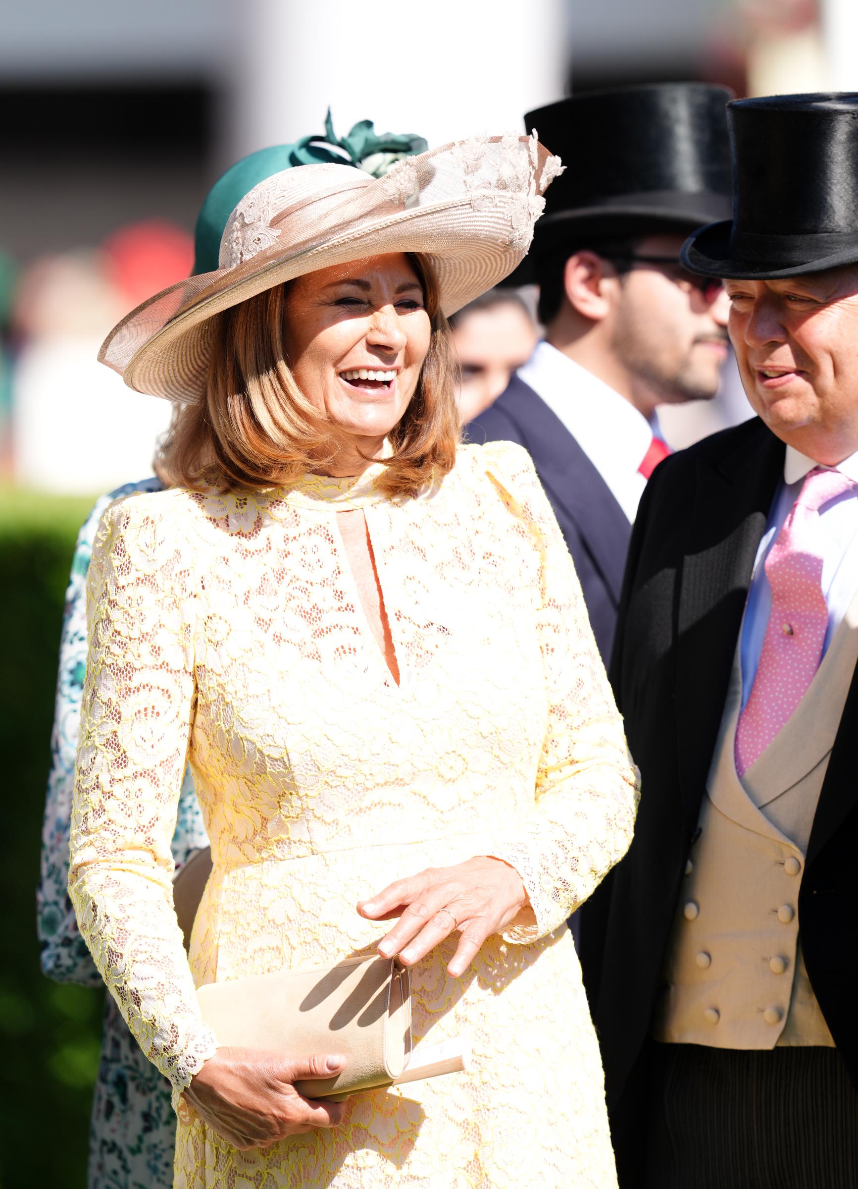 Carole Middleton beams in a pastel yellow lace dress and wide-brimmed hat as she arrives at Royal Ascot on June 18, 2025, joining other guests for the high-profile racing event.