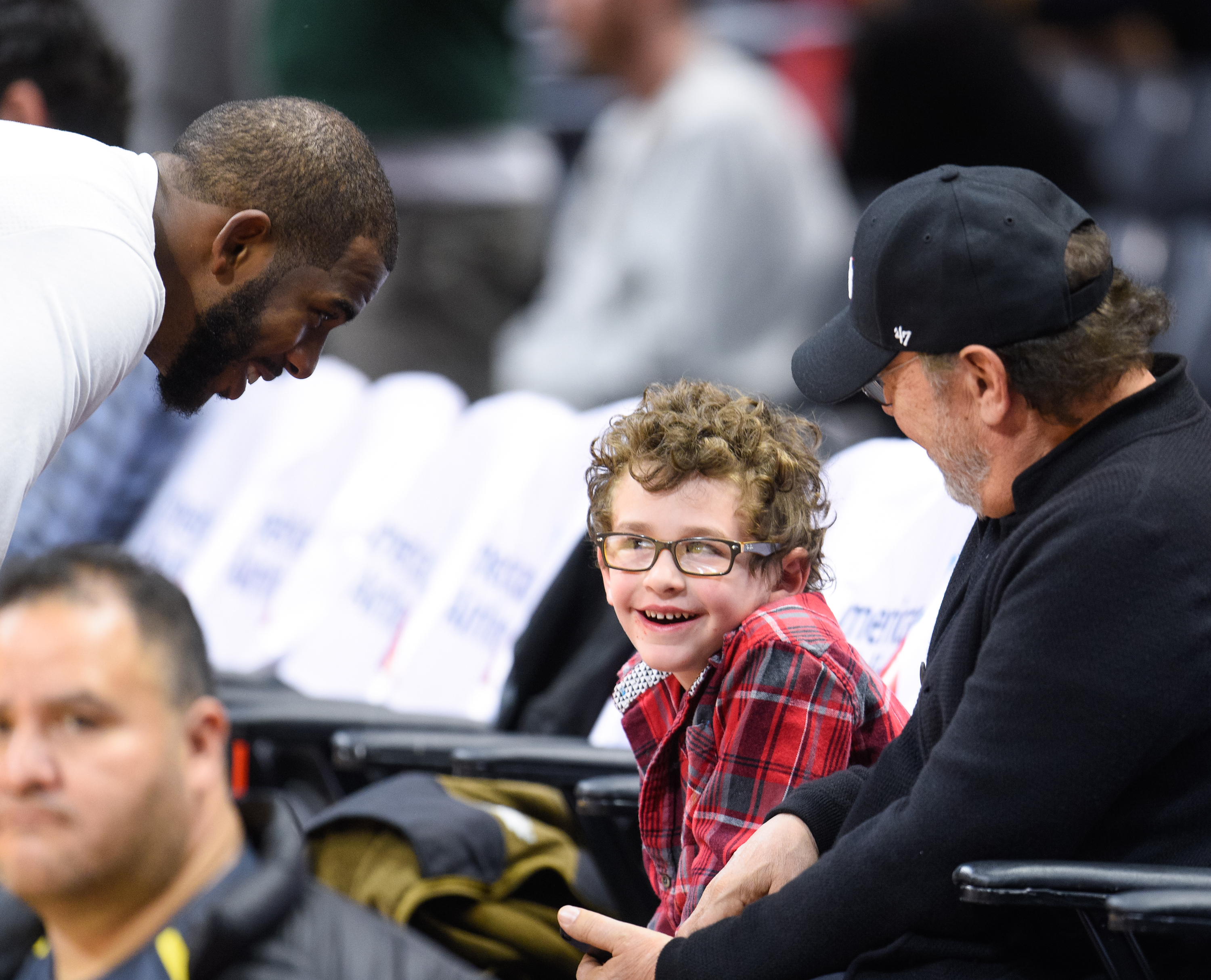 Chris Paul talking to Billy Crystal's grandson at a basketball game at Staples Center on November 29, 2015, in Los Angeles, California | Source: Getty Images