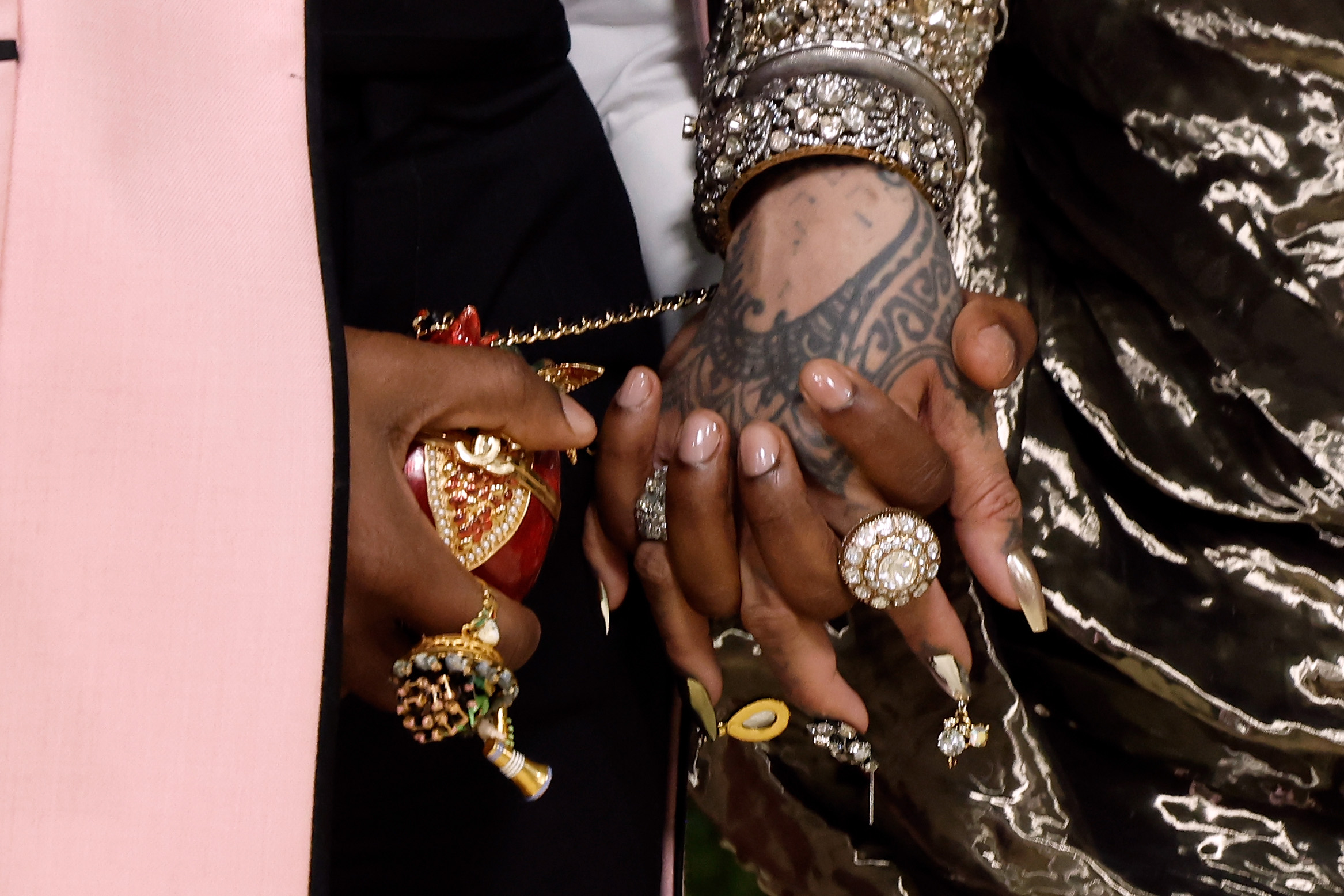 A$AP Rocky and Rihanna share a close-up moment, their hands layered with statement rings during the 2026 Met Gala celebrating "Costume Art" at the Metropolitan Museum of Art, in New York, on May 4. | Source: Getty Images