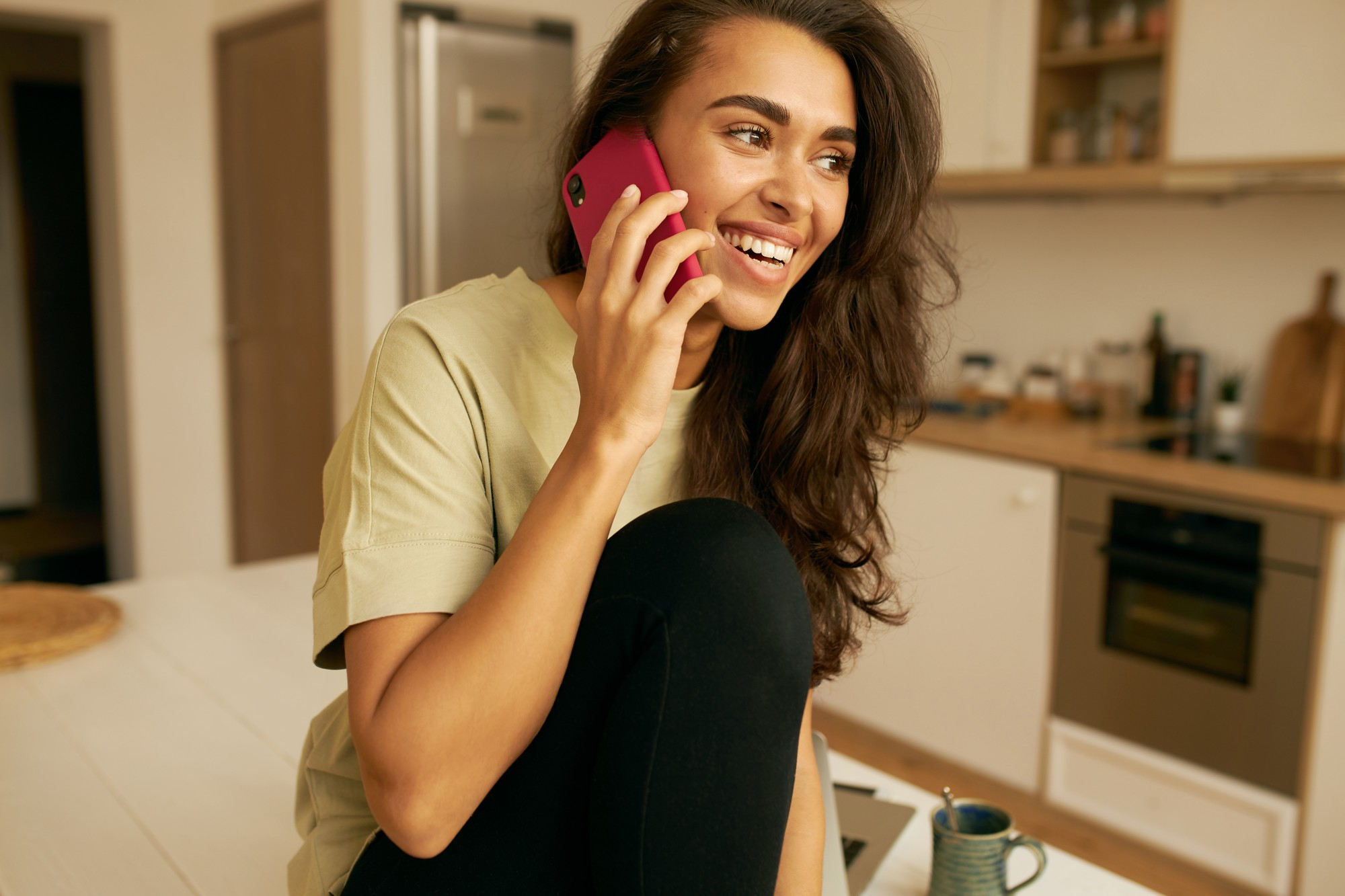 A happy woman speaking on the phone | Source: Freepik