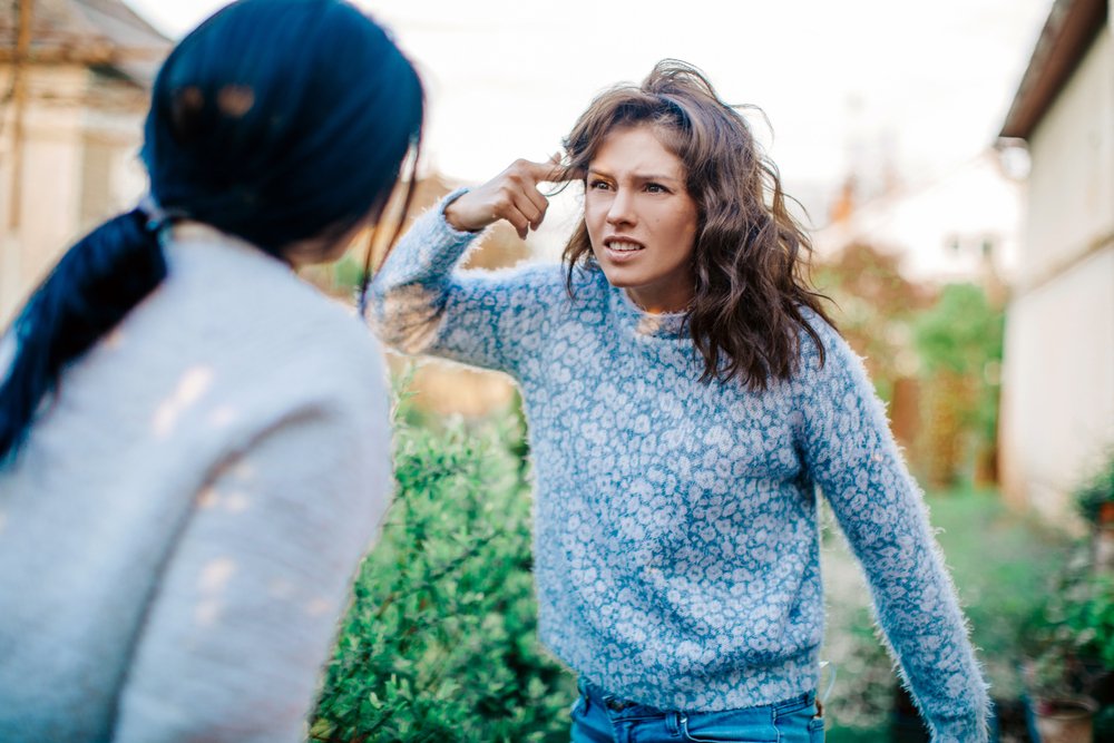 Two women screaming at each other during an argument | Photo: Shutterstocki