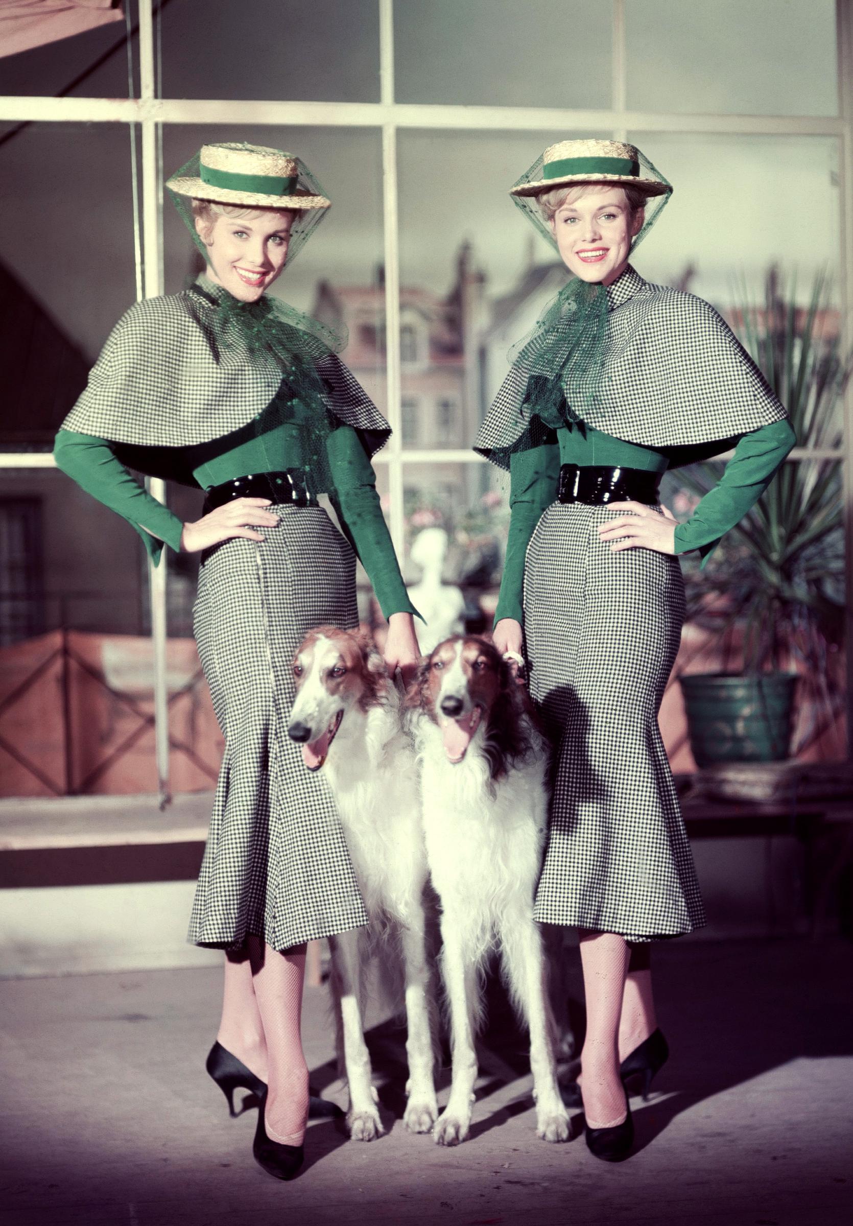 Alice and Ellen Kessler in a studio still with their dogs for the film "The Count of Luxembourg" in 1957 | Source: Getty Images