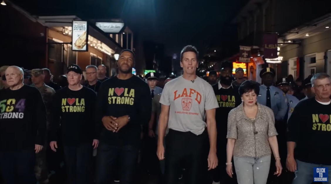 Michael Strahan and Tom Brady walk with a crowd of emergency responders on Bourbon Street, New Orleans | Source: YouTube/NFLonFOX