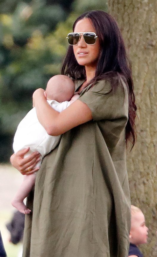 Duchess Meghan cradling Archie at the King Power Royal Charity Polo Day on July 11, 2019 Photo Getty Images