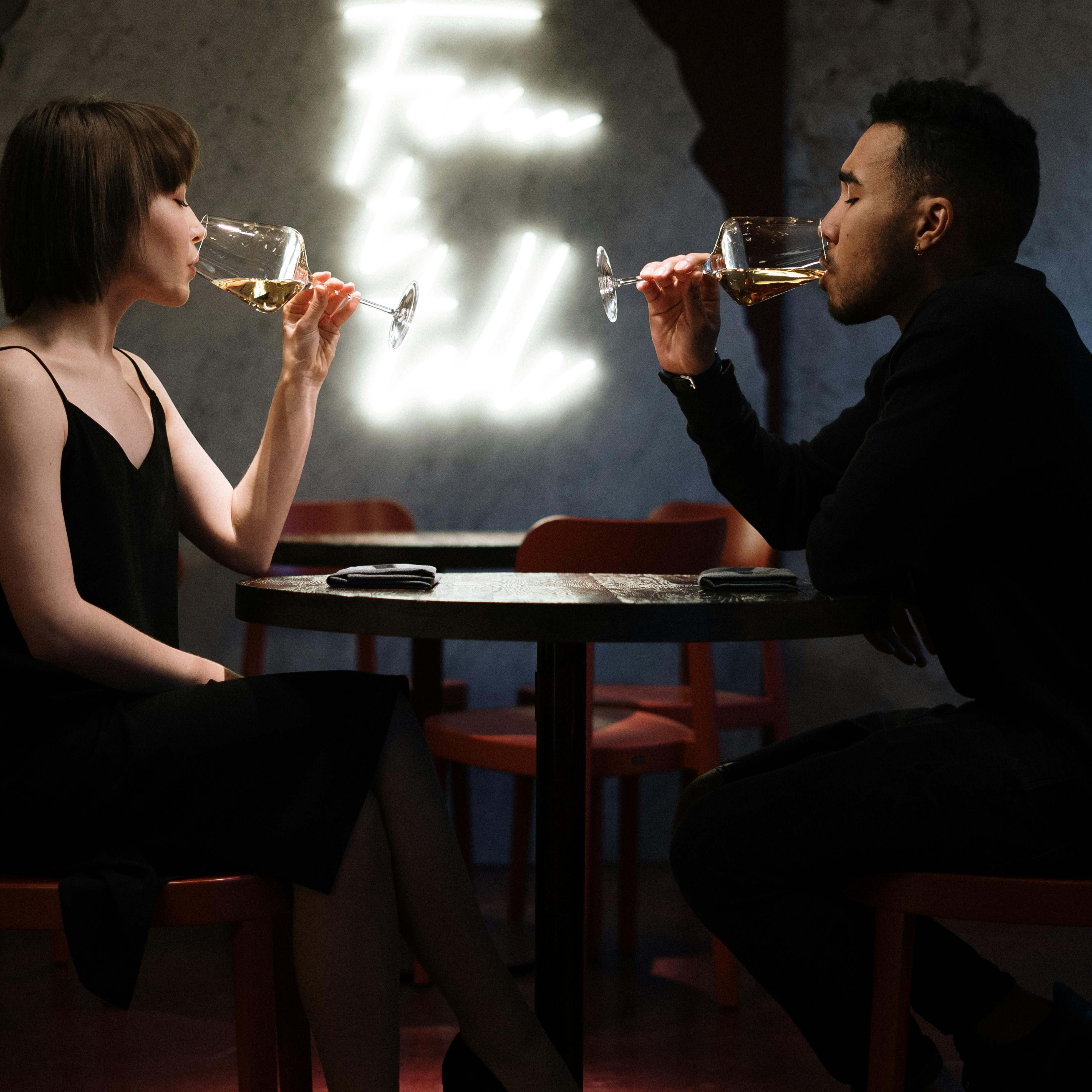 A woman and man sipping drinks socially | Source: Pexels