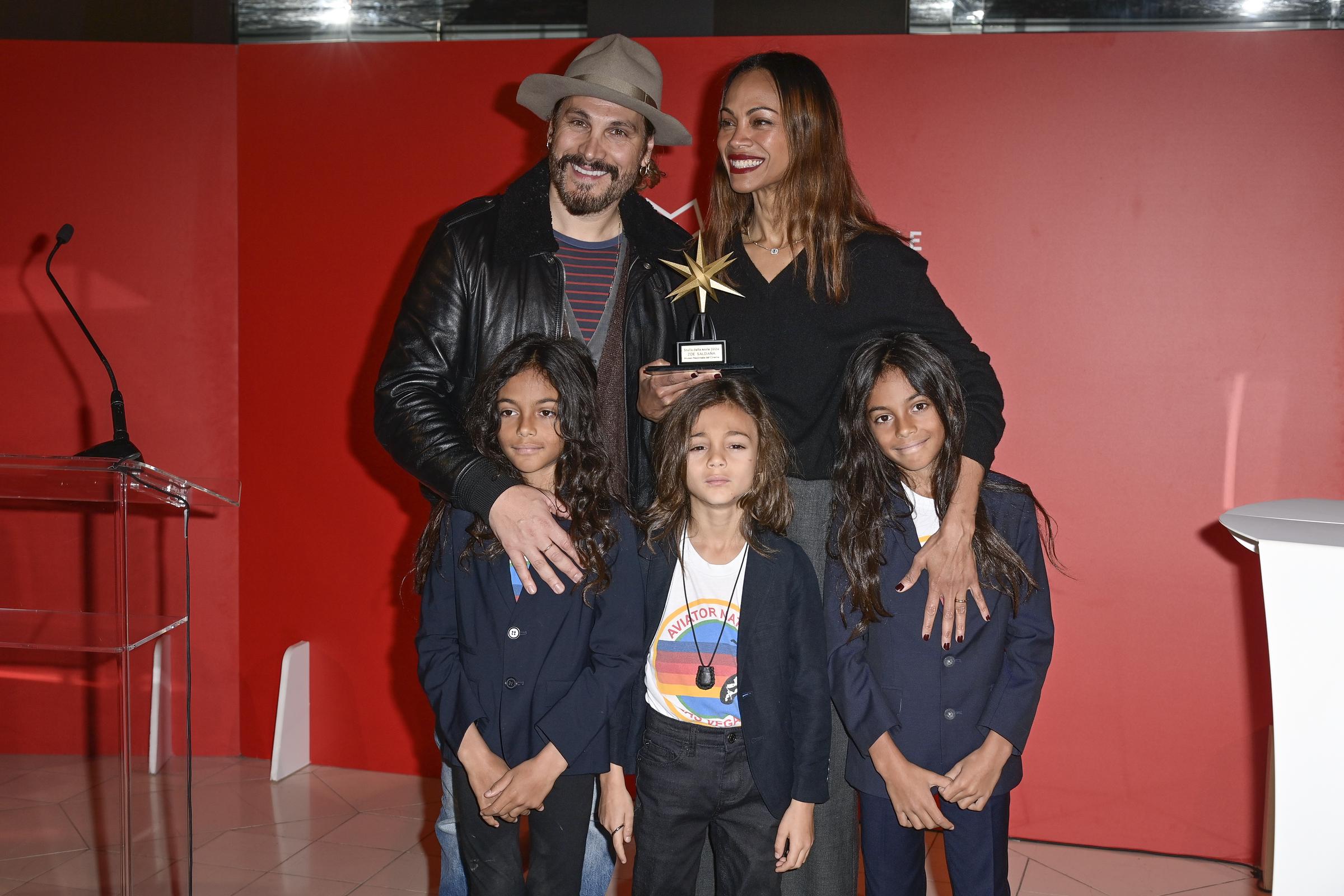 Marco Perego and Zoe Saldaña with their kids Cy, Bowie, and Zen Perego-Saldaña. | Source: Getty Images