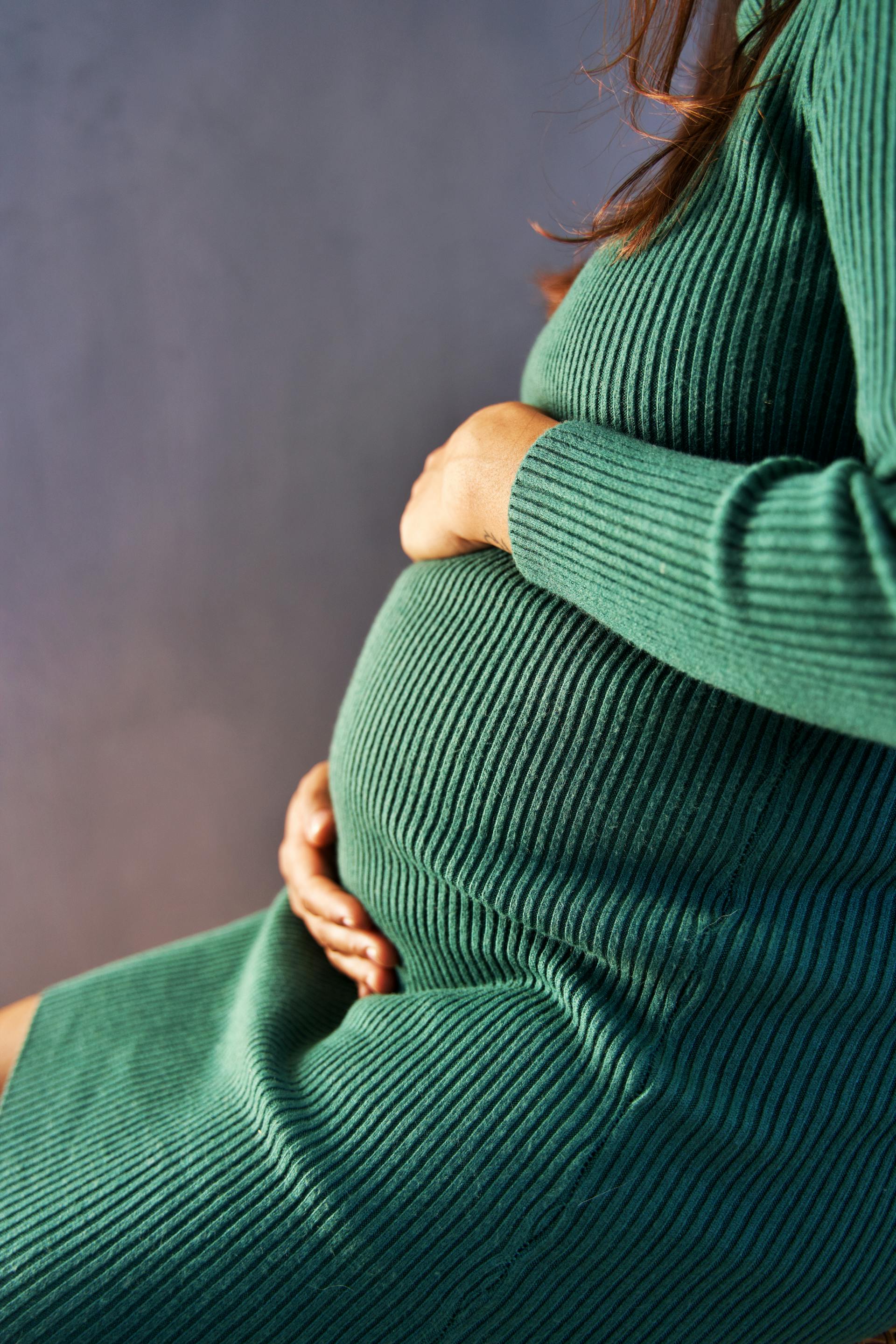 A pregnant woman holding her baby bump | Source: Pexels