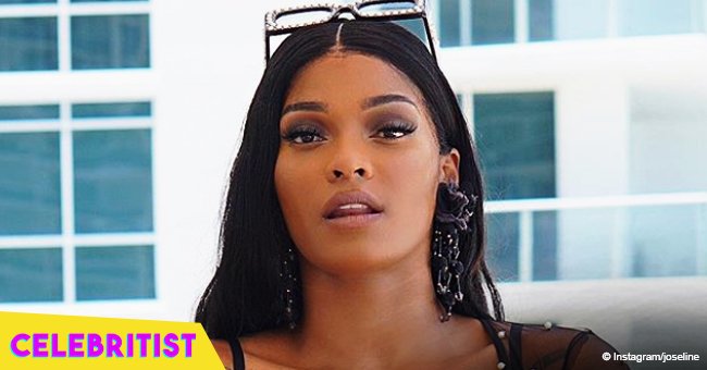 Joseline turns up the heat in long, snake-print dress in recent video