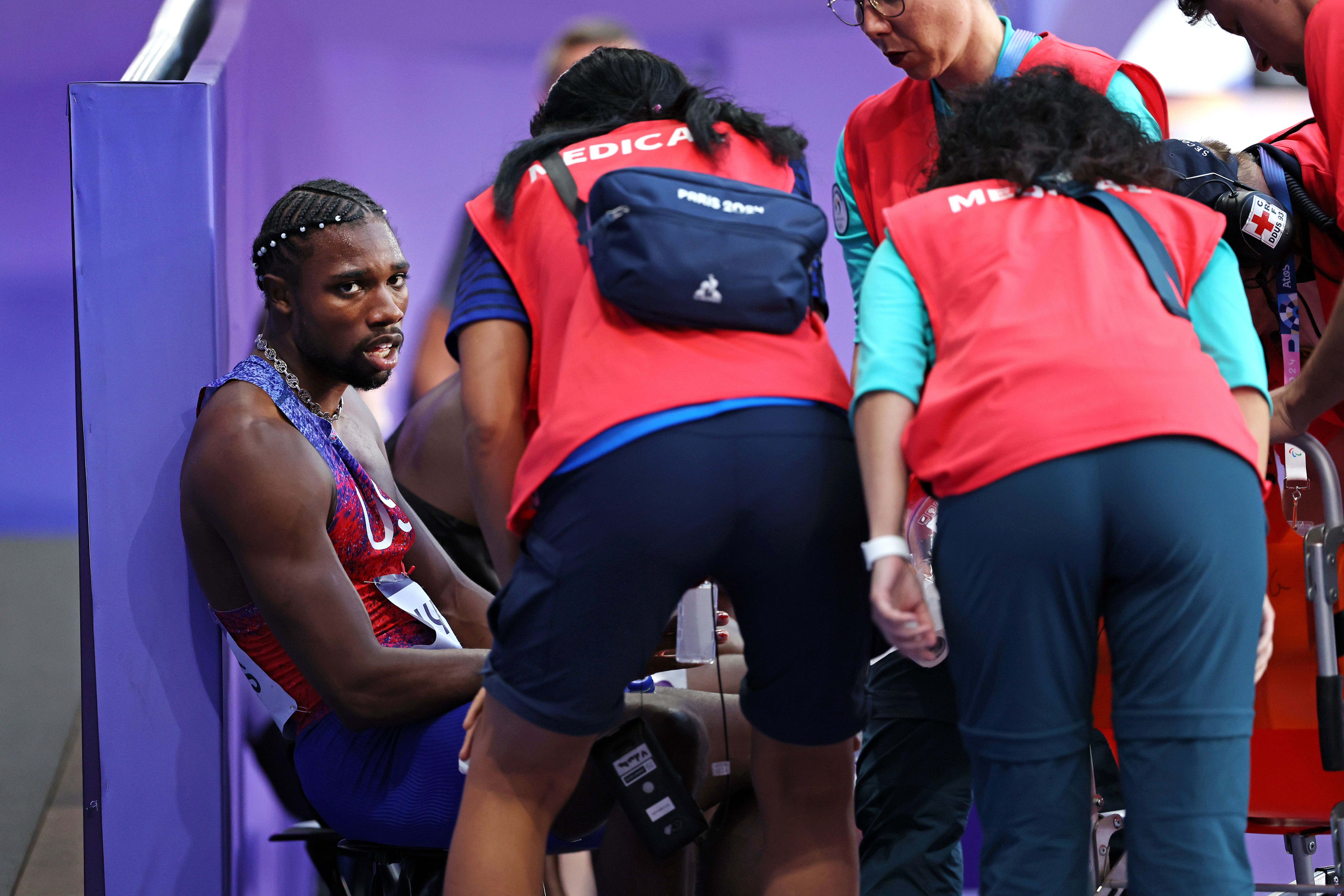 Noah Lyles of Team US gets assisted by medical staff after competing in the Men's 200m Final at the Paris Olympic Games Paris on August 8, 2024, in Paris, France | Source: Getty Images