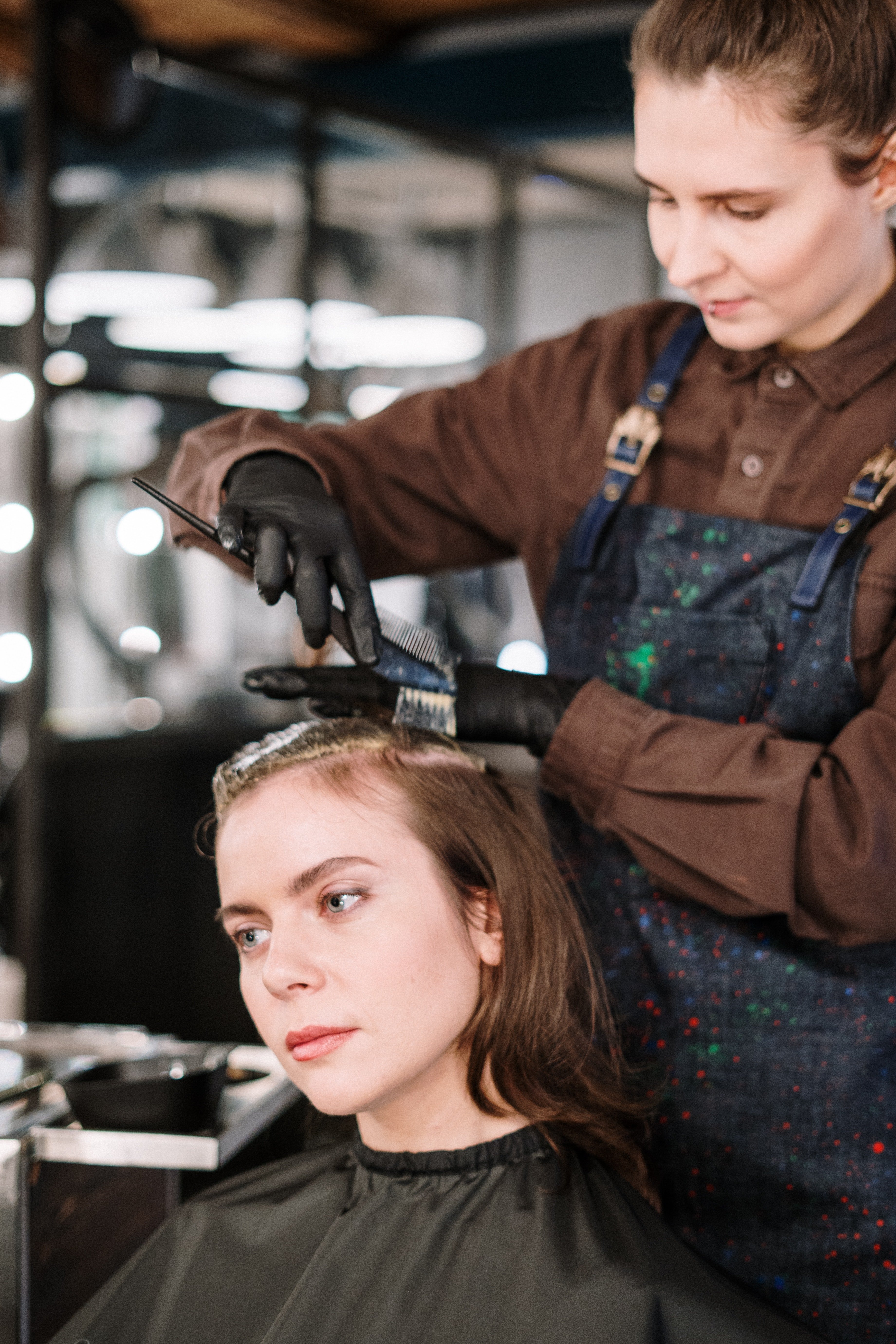 Woman getting a hair treatment at a salon | Source: Pexels